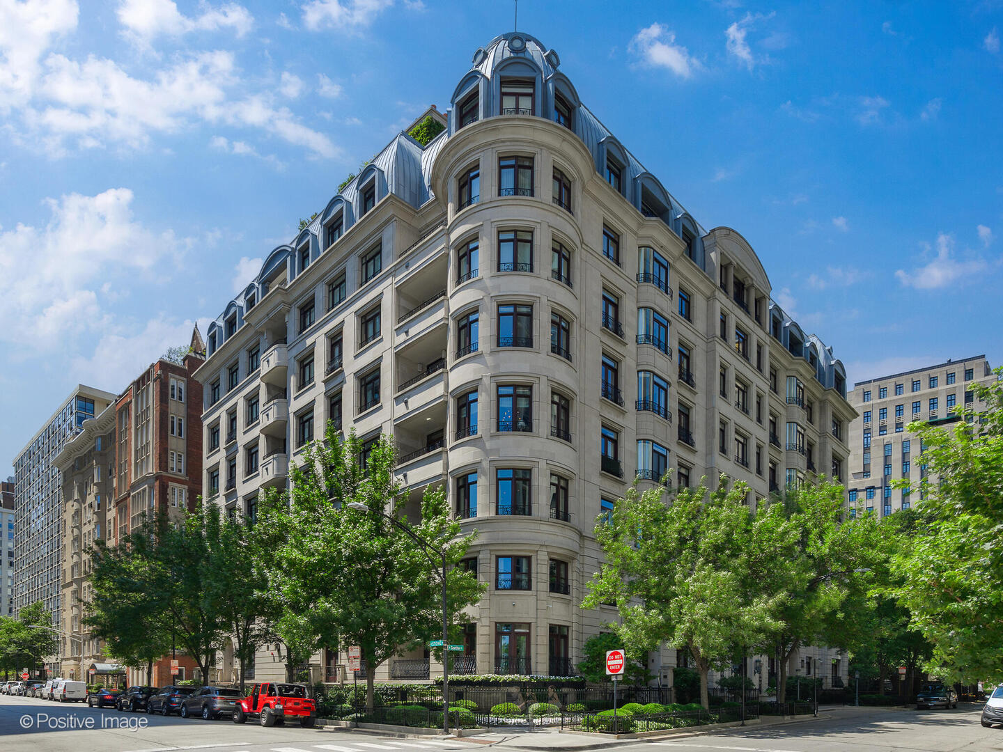 An absolutely breathtaking residence in Chicago's most private and exclusive Gold Coast boutique building spans over 5,200 square feet and is a meticulously designed space. A rare offering, this home embodies timeless sophistication and European grandeur with its French-inspired architecture, classic detailing, and impressive finishes. Every inch of this magnificent property is crafted with uncompromising attention to detail. From the moment you step into the stately marble foyer, you are enveloped in a world of elegance. Dramatic ceiling details, intricate millwork, curated lighting, and artful tilework elevate each room to a gallery of fine design. Incredible natural light throughout in its grand windows, its formal living room is anchored by a striking gas fireplace, offering an inviting space for gracious entertaining or quiet repose. The generously proportioned formal dining room flows seamlessly from the living room, perfect for hosting intimate dinners or lavish gatherings. A culinary showpiece, the oversized eat-in DeGuilio kitchen features custom wood cabinetry, 11 foot stone island, top-of-the-line appliances, rich Birger Juell hardwood floors, a walk-in pantry, and an adjoining butler's pantry complete with wet bar-ideal for effortless entertaining. The richly paneled library great room, with private terrace and panoramic views of Lake Michigan, offers a warm and luxurious retreat. The opulent primary suite boasts a sun-drenched corner bedroom with lush treetop views, a private veranda overlooking the park, a sitting room with wet bar, and a spectacular custom dressing room walk-in closet featuring a center island. The spa-inspired bath is a haven of relaxation, complete with dual vanities, an oversized shower, a Whirlpool tub, and a private water closet. 2 additional en-suite bedrooms offer ultimate comfort and privacy, while a 4th bedroom is currently used as a cozy den. Additional elevated spaces include 2 perfectly appointed powder rooms, and a fully equipped laundry/mudroom. This unit has immense storage space and all mechanicals and smart home system have been recently updated. This extraordinary home includes 2 heated deeded garage parking spaces and additional private storage closet. Situated within an impeccably maintained, service-rich building featuring 24-hour door staff, an onsite manager and engineer, and a beautiful common rooftop terrace with sweeping city and lake views, it is ideally located in the heart of the Gold Coast, just steps from Oak Street Beach, Michigan Avenue, world-class dining, parks, and cultural landmarks. This is a once-in-a-lifetime opportunity to own a truly magnificent residence that exemplifies the very best of Chicago luxury living.