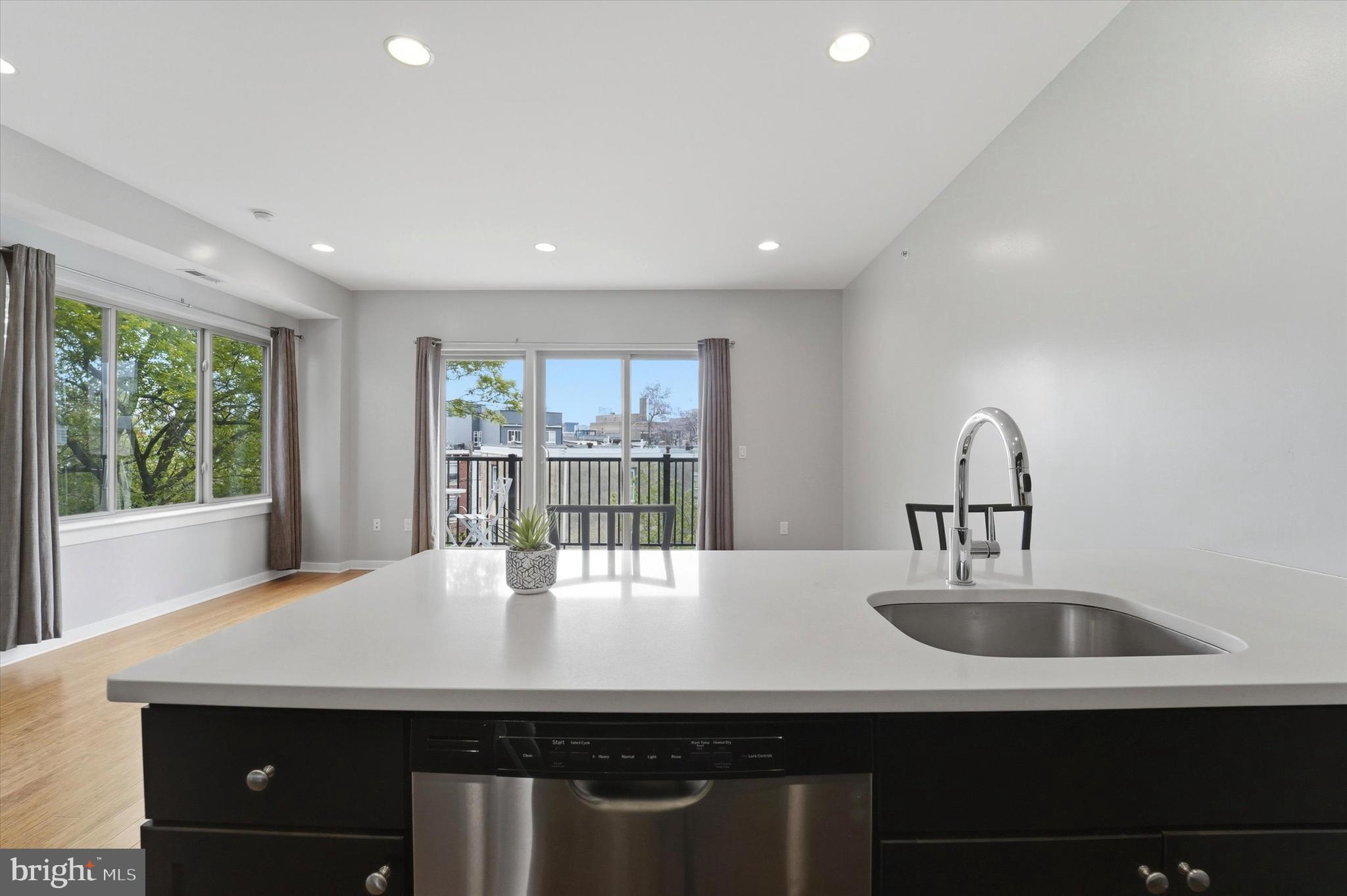 Welcome to 1608 Ridge Avenue Unit 403 a stunning newer construction 1 bedroom condo designed for modern city living. The light-filled, open living area and exceptional private outdoor space feature a bright open concept layout where the living dining and kitchen areas flow seamlessly together anchored by floor to ceiling corner windows that flood the space with natural light. This creates an airy inviting feel. The kitchen is both stylish and functional, featuring expansive counter space on both sides stainless steel appliances and abundant cabinetry making it ideal for cooking entertaining or everyday living. Step directly onto your private balcony spanning the living space perfect for morning coffee or evening relaxation. Then, take full advantage of your exclusive rooftop deck a true showpiece offering sweeping Center City skyline views and the ultimate setting for hosting gatherings enjoying summer nights or unwinding above the city. The spacious bedroom offers a quiet retreat with a walk in closet while additional features include an in-unit washer and dryer elevator access and modern finishes throughout. Ideally located in the heart of the vibrant Fairmount and Francisville corridor, it is just minutes from Center City, Temple University, parks, restaurants and the Broad Street Line.  This is a wonderful opportunity for a first time buyer, young professional or investor seeking low maintenance living with standout indoor and outdoor space in one of Philadelphia's most dynamic neighborhoods.  Minutes from Fairmount Park, the Schuylkill River Trail and the Museum District.  Book your tour for this amazing airy and bright condo with multiple outdoor spaces before it's gone.