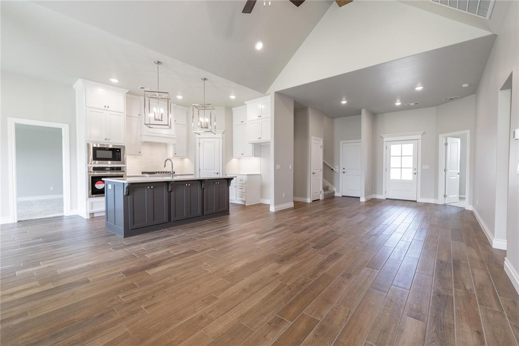 This Sage Bonus Room 1 floor plan includes 2,550 Sqft of total living space, which includes 2,300 Sqft of indoor living space and 250 Sqft of outdoor living space. There's also a 625 Sq Ft, three car garage with a storm shelter installed. This home offers 4 bedrooms, 3 full bathrooms, 2 covered patios, and a bonus room! The living room features an outstanding cathedral ceiling, a beautiful fireplace with our stacked stone surround detail, large windows, and wood-look tile. The kitchen has decorative tile backsplash, built-in stainless-steel appliances, well-crafted cabinets to the ceiling, 3 CM countertops, a corner pantry, and a large center island with a trash can pullout. The primary suite boasts an extraordinary, sloped ceiling detail with a ceiling fan, sizeable windows, and our cozy carpet finish. The attached spa-like primary bath features a dual sink vanity, a European walk-in shower, a free-standing tub, a private water closet, and an incredible walk-in closet that will leave you absolutely speechless. The covered back patio offers a wood burning fireplace, a TV hookup, and a gas line. This home also features healthy home technology, a fresh air ventilation system, a tankless water heater, and so much more!