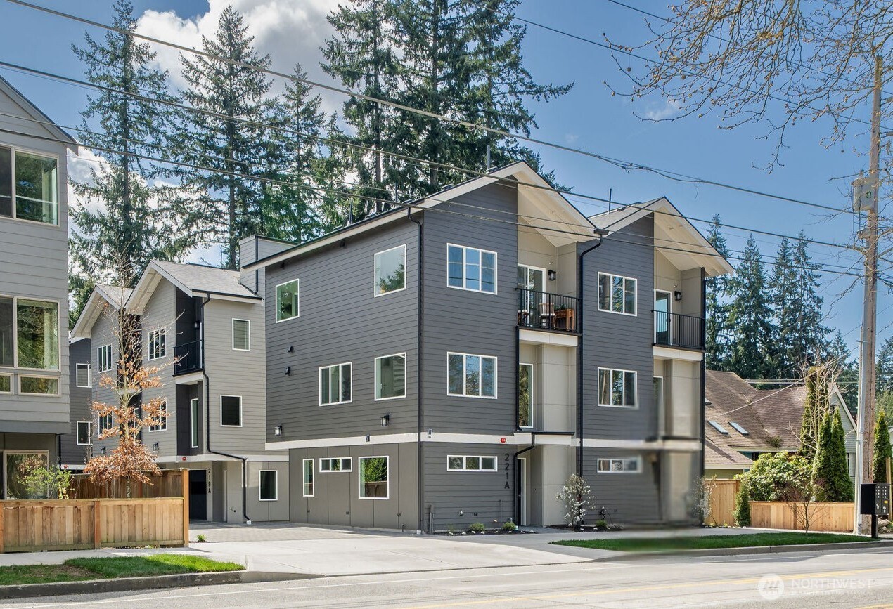 Indulge in the pinnacle of new construction living in this exceptional Shoreline townhome, one of six residences in a highly sought-after development. Thoughtfully designed across three levels with outstanding finishes throughout & no HOA.The main floor is an entertainer's dream featuring a chef's kitchen w/gas range, walk-in pantry, & generous dining space flowing seamlessly into a bright living room bathed in natural light. A convenient powder room completes the level.Upstairs, discover dual primary suites — each with a private ensuite bath — offering the ultimate in flexibility & privacy. Mini-split systems ensure year-round climate-controlled comfort throughout the home.The lower level features a versatile bonus room ideal as a guest bedroom or home office, plus an attached garage w/in-unit laundry.Crown your living experience on the private rooftop deck with sweeping territorial views — your personal outdoor retreat above it all.Steps to the NE 185th St Light Rail Station & perfectly positioned in Meridian Park with easy access to dining, shopping, & I-5. Commuting has never been easier — Seattle & Shoreline are at your doorstep.