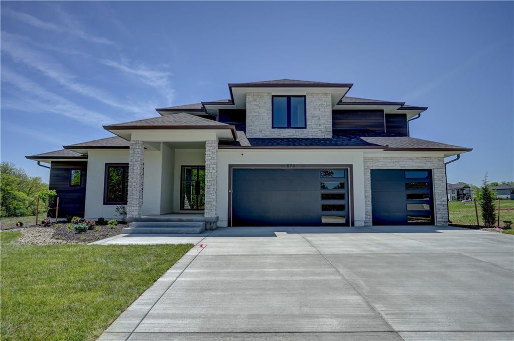 Welcome to a truly exceptional custom-built home by KC Custom Homes where thoughtful design meets elevated living. Offering just under 5,000 square feet of beautifully finished space across all three levels, the Emerson floorplan delivers both luxury and functionality in every detail.The exterior makes a striking first impression with its blend of composite, stone, and stucco, complemented by $10,000 in professional landscaping and a painted 3-car garage. Inside, the home opens to a light-filled layout with modern glass railings and handrails that create a clean, architectural feel throughout.At the heart of the home is a chef’s kitchen designed to impress, featuring granite carried seamlessly up the backsplash wall, built-in oven and microwave, and a dishwasher, all thoughtfully selected for both performance and style. Just beyond, the show-stopping butler’s pantry is incredible: massive, beautifully designed, and equipped with an undermount bar fridge, making it perfect for entertaining or everyday convenience.The main level offers a highly desirable primary suite along with a dedicated office and convenient laundry room. Upstairs, you’ll find three spacious bedrooms, with the option to add a stackable washer and dryer for added flexibility. The fully finished lower level expands your living space with two additional bedrooms, a setup for a full-size refrigerator, and ample room for recreation or guests.With a total of six bedrooms, four full bathrooms, and two half baths, this home easily accommodates both everyday living and entertaining. Built with quality in mind, it features a Franklin engineered plumbing system and represents a top notch level of construction and finish. This is a third tier home, which grants you access to the lake and all the lifestyle perks that come with it.Every inch of this home reflects intentional design, high-end finishes, and modern comfort. Simply put, it’s absolutely stunning.