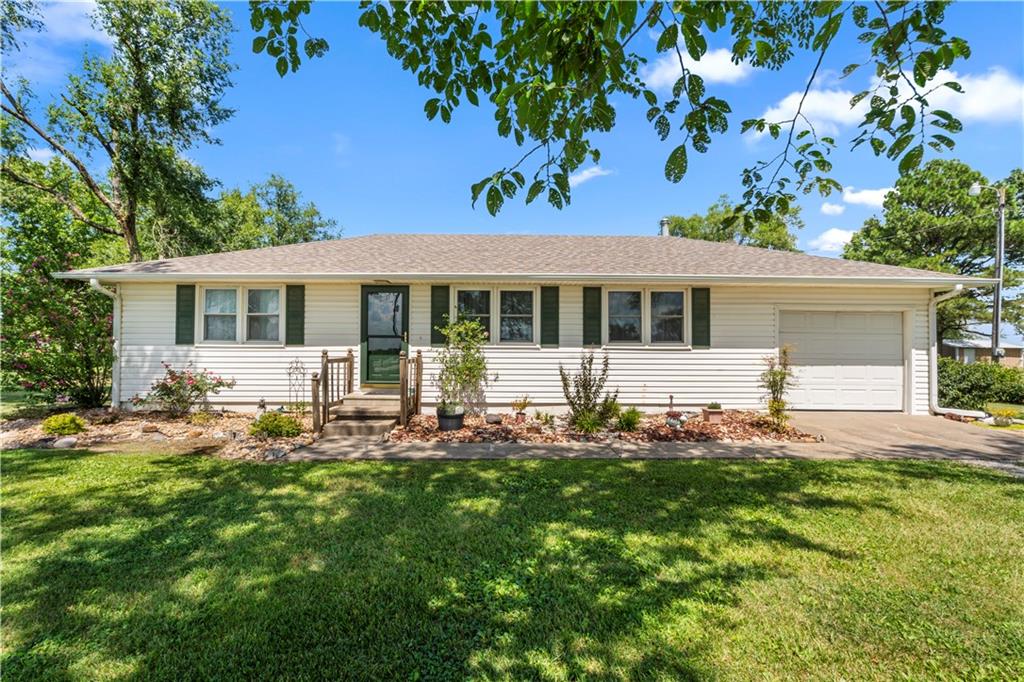 Welcome home to this charming one-level property just east of Nevada, Missouri! Built in 1985, this 3-bedroom, 1-bathroom home is ready for its new owners. Enjoy peace of mind with a list of recent improvements. The heat and air systems and water heater were all replaced in 2025, ensuring comfort and efficiency for years to come. The home's exterior features durable vinyl siding, while the interior boasts newer flooring and appliances. The beautifully landscaped yard is a true standout, complete with mature shade trees and a storage shed for all your tools. The property offers easy access to 54 Highway with convenient highway frontage.