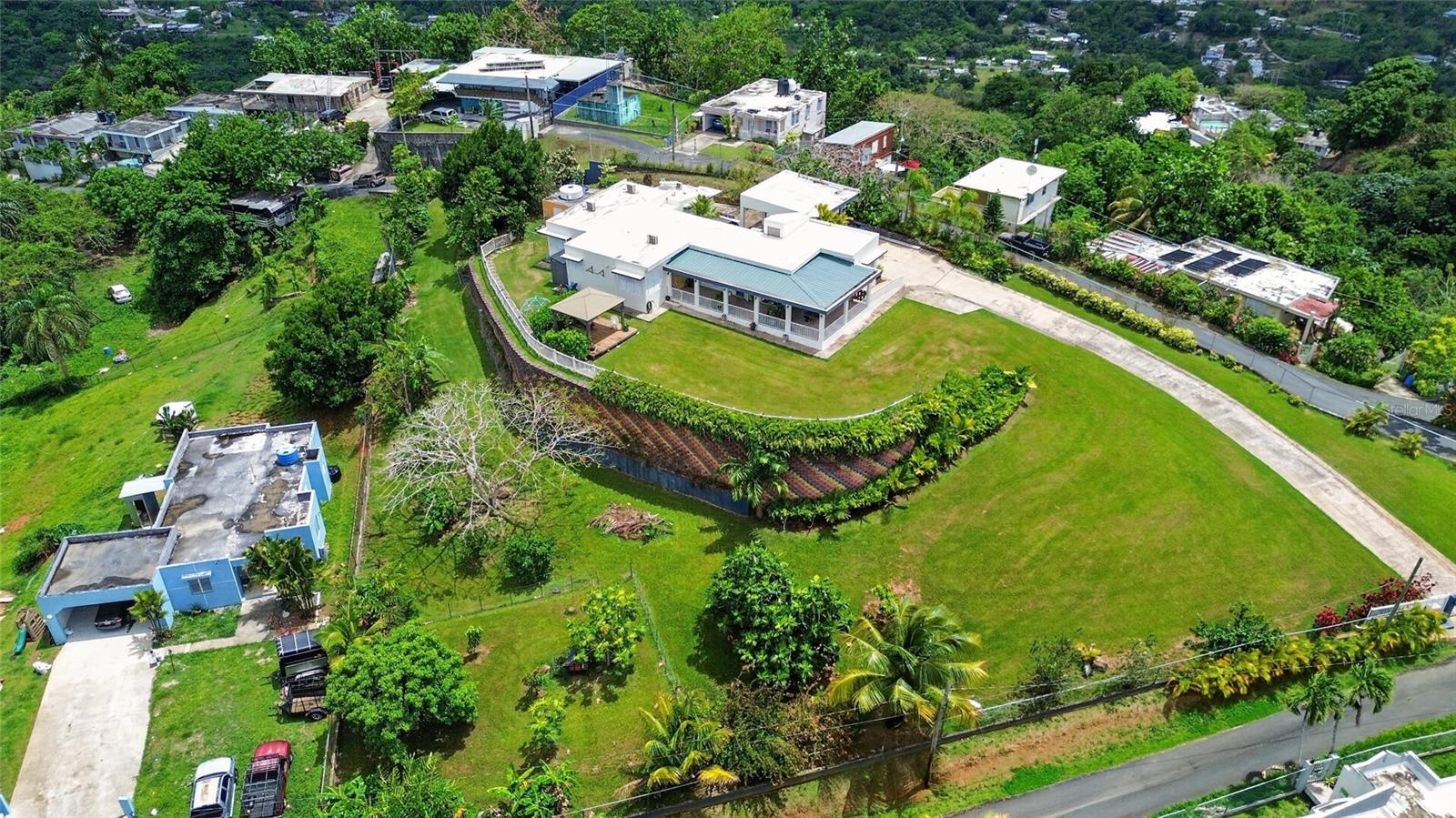 Perched at the top of a hill in Guaynabo, this residence offers incredible views, refreshing breezes, and abundant natural light throughout.Set on an expansive 1-acre lot, the property combines privacy, space, and everyday comfort, delivering the feel of a country retreat just minutes from the city. Located only 7 minutes from the expressway, it offers convenient access while maintaining a peaceful, private setting.Designed for resilient living, the home is equipped with a generator, providing added peace of mind and energy reliability. It also features a two-car garage, a gazebo ideal for outdoor entertaining, and a playground area, creating a comfortable environment for both family living and gatherings.With its elevated position, generous lot, natural surroundings, and strong energy resilience, this Guaynabo hilltop residence offers a rare blend of privacy, views, convenience, and practicality.
