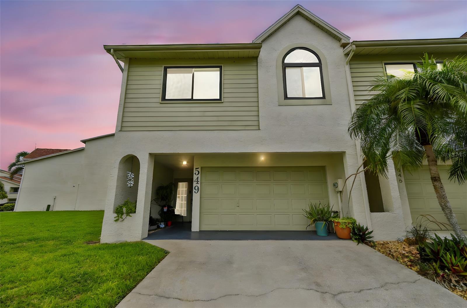 Welcome to Curlew Landings in Dunedin!  This stunning 2 bedroom, 2.5 bath townhouse has been completeley remodeled.  Did I mention a bonus area on the lower level and attached garage??  All you have to do is move in and enjoy! No detail was spared in this high-quality renovation, from the stylish finishes to the thoughtful design that maximizes space and comfort. Inside you’ll find open living with a wood-burning fireplace, a gorgeous kitchen, a screened lanai for relaxing, and a flexible bonus room perfect as a 3rd bedroom, office, or media space. This townhome has hurricane impact windows, roof and a/c replaced in 2018. Enjoy easy access to the community pool, tennis courts, clubhouse, Pinellas Trail, Dunedin Causeway, Honeymoon Island, shops, breweries, restaurants, and vibrant downtown Dunedin. Golf carts are allowed with proper licensing, and boat slips may be available for rent. All ages welcome as is your fur baby!.  Call me for your private showing and be part of this Dunedin community.