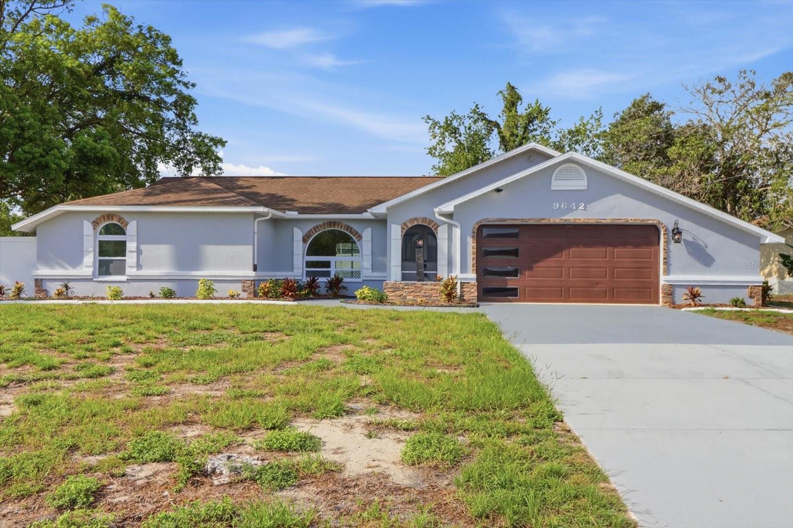 Welcome to this beautifully TOTALLY UPDATED FROM TOP TO BOTTOM 3-Bedroom, 2-Bathroom POOL home offering the perfect combination of style, functionality, and space! Situated on a CORNER LOT with NO HOA and no flood zone, this property features an Oversized 2-Car Garage, a fully FENCED backyard, and side access with plenty of room to park your RV, boat, trailer, or jet skis etc.  Step through the screened front entry and Double Front Doors into a bright, open floor plan where your eyes are immediately drawn through the sliding glass doors to the inviting pool and outdoor living area. The interior showcases luxury finishes throughout, including updated flooring, lighting, and fixtures.  The stunning kitchen is truly the heart of the home, featuring QUARTZ countertops, a dramatic Waterfall Island, updated cabinetry, modern appliances, designer lighting, and a convenient pantry closet. The adjacent dining area flows seamlessly into the spacious living room, making this home ideal for everyday living and entertaining. The private primary suite is tucked away at the rear of the home and offers peaceful backyard views, a generous walk-in closet, dual vanities, a private water closet, and an oversized walk-in shower. On the opposite side of the home, two additional bedrooms each feature walk-in closets and share a guest bathroom with a tub/shower combination and direct access to the pool area, making it a perfect pool bath.  Just off the dining room, you'll find a spacious laundry room complete with a utility sink and plenty of room for additional storage. The Oversized Garage offers Epoxy Flooring, a dedicated workspace, and a separate exterior door leading to the backyard.  Outside, enjoy your private backyard oasis with plenty of room for entertaining, pets, or hobbies. A large storage SHED provides extra space for tools and equipment. ROOF (2017) HVAC (2020) New WATER HEATER. Great location with shopping, dining, medical facilities, and everyday conveniences just minutes away.