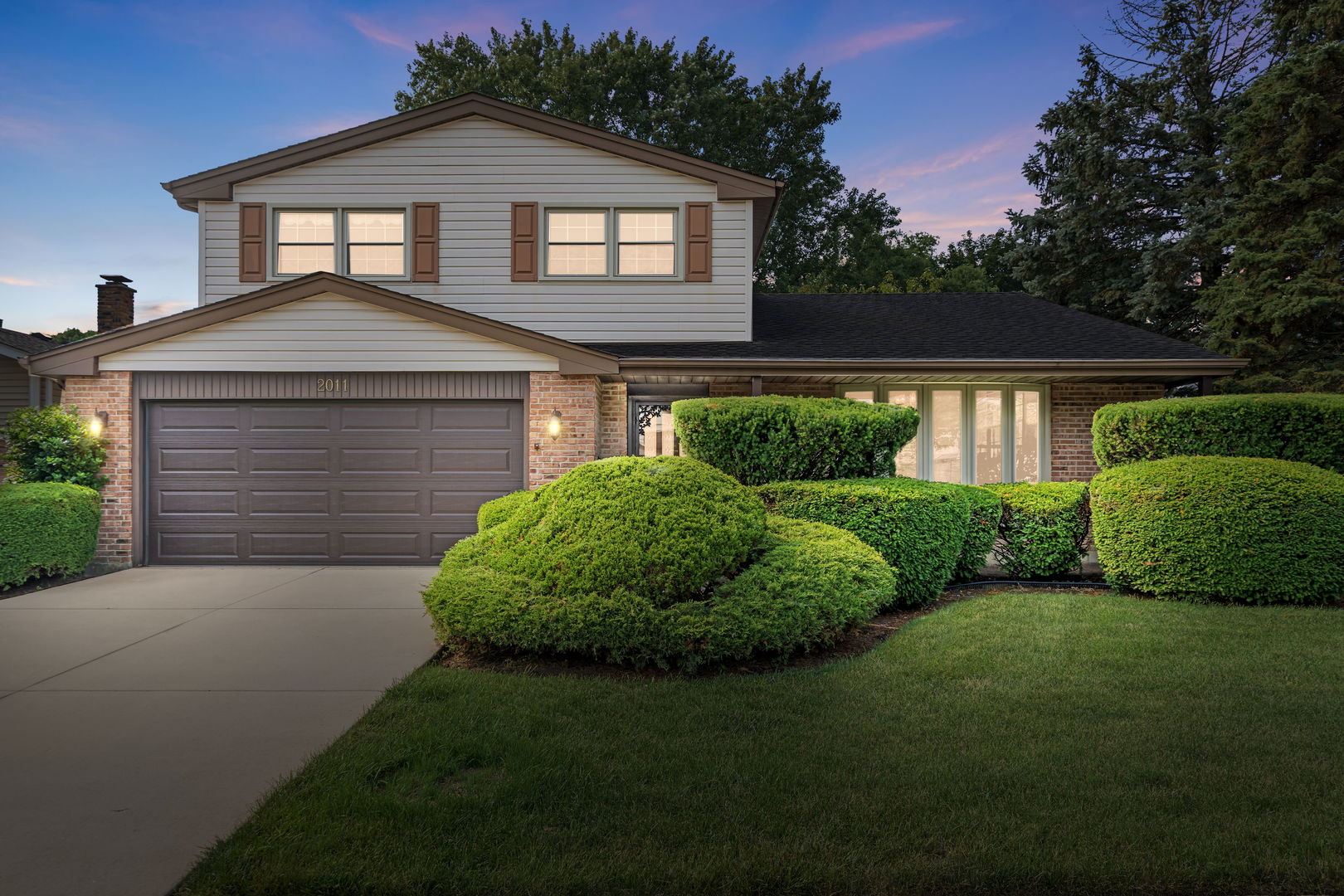 Don't miss this rare opportunity to own a beautifully maintained 3-bedroom, 2.5-bathroom home in the highly desirable North Gate neighborhood - just a short walk to Lake Arlington and Wildwood Park. Whether you're entertaining guests, relaxing by the fireplace, or enjoying a morning coffee surrounded by nature, this home offers a seamless blend of charm, function, and location. Step into spacious entryway that flows effortlessly into the bright living and dining rooms, featuring vaulted ceilings, a dramatic 6' wall of windows and gorgeous refinished hardwood floors - creating an open and inviting space that feels both elegant and comfortable. The kitchen is well designed with arched masonry over the sink and window, a double oven for the baking enthusiasts or large holiday gatherings, dishwasher, ample counter and cabinetry space. Enjoy your morning coffee in the delightful breakfast area while looking out the large window into beautifully landscaped backyard complete with mature trees and flourishing garden beds. Steps down to the cozy family room that offers the perfect retreat - featuring a gas fireplace, trendy wood paneling, hardwood floors, and sliding glass doors that lead out to the thoughtfully designed patio with graceful curves for outdoor dining and relaxing. On the lower level, you'll also find a convenient half bath, a laundry room with utility sink.  There is extra living space for a playroom, home gym, or media room in the partially finished sub-basement - along with a full room of extra storage. Upstairs, the primary suite is a perfect place to relax with double closets, large sink area, and a separate shower and toilet area. Two additional nicely sized bedrooms and a full hall bath with double sinks provide plenty of space for family, guests, or a home office setup. Recent upgrades include new concrete driveway, epoxy-finished garage floor, and maintenance-free gutters with guards. All this in a vibrant, active community known for its excellent schools, convenient shopping and dining, and proximity to beautiful parks and trails. This home isn't just a place to live - it's a place to thrive.