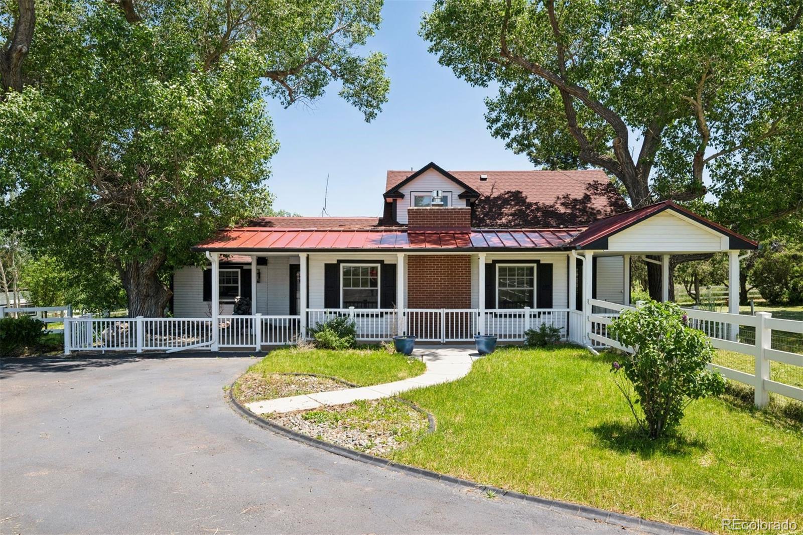 Spanning 55 acres of pasture and meadow, this Elbert ranch pairs a fully renovated farmhouse with a well-equipped collection of outbuildings designed for equestrian use, storage, and day-to-day country lifestyle. With multiple barns, a fenced arena, and a drive-through equipment building, the infrastructure is already in place for a working property, with the flexibility and possibility for what comes next. Inside, the three-bedroom, three-bathroom home has been thoughtfully refinished. The kitchen centers around a large island with storage and is equipped with stainless steel appliances, soft-close cabinetry with ample storage and a breakfast bar. The main living area, anchored by a limestone gas fireplace, is just off a dedicated mudroom with built-in storage and a dog wash that supports the demands of the land. Through the main entry, a formal dining room connects to a private office and a second living area with walk-out access to the back patio. Systems including radiant floor heating, LG mini splits, and a tankless water heater provide comfort and efficiency. The main level primary suite offers heated floors and a quiet, private setting. Two additional bedrooms and a full bath are located upstairs, with flexible space for guests, work, or additional living. The outbuildings are well suited for equestrian use, including a three-stall barn with rubber mats, automatic waterers, turnouts, and hay storage, along with additional barn structures that provide space for equipment, workshop use, or continued improvement over time. A detached three-car garage with vaulted ceilings and epoxy floors adds further utility, while the fenced yard surrounding the home creates a defined and usable space separate from the surrounding acreage. Located just 20 minutes from Castle Rock with fully paved access, this is a property that supports both the everyday and life on the land. The adjacent property is also available and may be purchased together or separately.