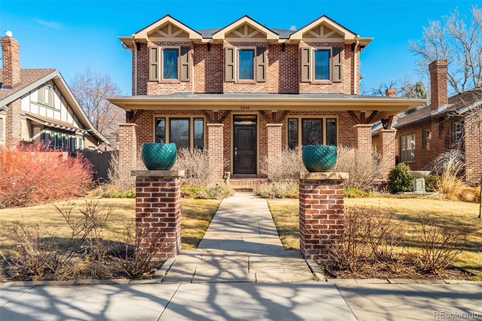 Located on a quiet block in Park Hill, this elegant five-bedroom, four-bath brick two-story blends classic charm with modern livability. The open kitchen anchors the main level with a large Quartz island, bar seating, six-burner gas range, and a well-appointed butler’s pantry. The kitchen flows seamlessly into the great room which features a gas fireplace and fully retractable glass wall system that leads to the fully fenced backyard. Colorado outdoor living is enhanced by the covered deck, hot tub, outdoor shower, paver patio, and gas firepit, while mature perennial landscaping and garden planters create a private oasis. Complementing the main floor, a formal dining room and main-floor study with French doors add flexibility. Everyday function is elevated by the generous mudroom leading to the attached, two-car garage—complete with built-ins and access to a dog run. Upstairs, the spacious primary suite features a five-piece bath and dual walk-in closets.  Across the hall are two additional bedrooms with a jack-and-jill bathroom, and a convenient laundry room. The finished basement offers a large recreation room, wet bar, two conforming bedrooms, a functional space for work or crafts, and a spacious storage and mechanical room. Thoughtful upgrades like remote-controlled window coverings, radon mitigation, a new 2024 furnace, plus easy access to neighborhood dining, shopping, and parks, complete this exceptional home.