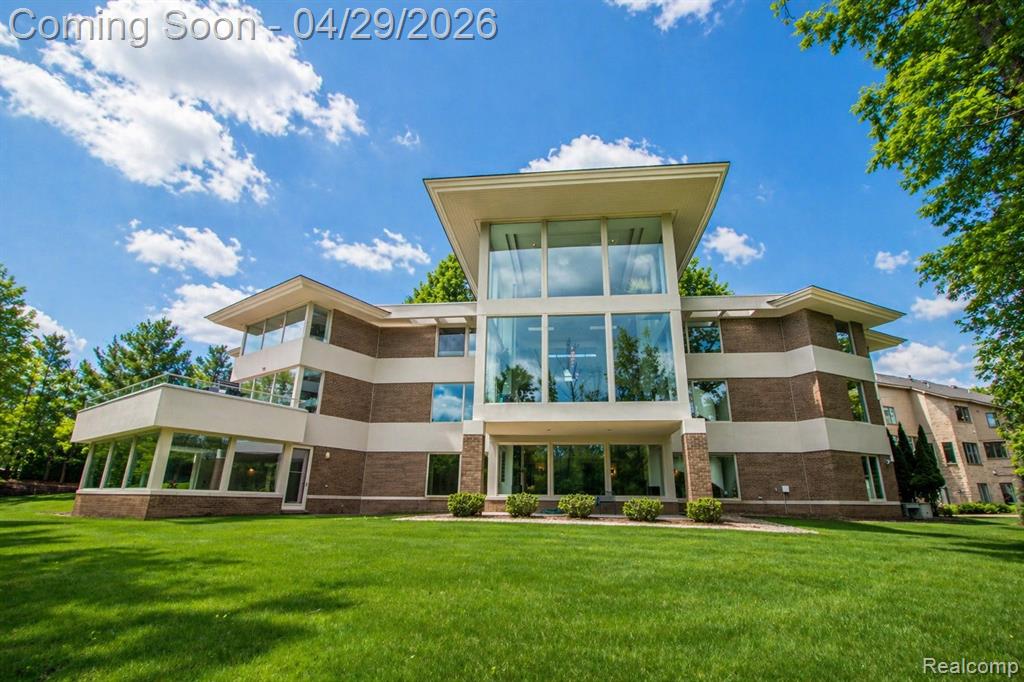 Architecturally striking estate designed by AZD Architects, overlooking a serene nature preserve with a small lake, offering approximately 10,000 square feet of refined living space with 6 bedrooms, 7 full baths, and 3 half baths. A dramatic two-story granite foyer opens to an expansive great room with floor-to-ceiling windows and a statement fireplace, creating a bold yet inviting focal point. The chef’s kitchen is appointed with stainless steel appliances, granite countertops, and flows seamlessly into a warm, inviting family room with its own fireplace. The primary suite serves as a private retreat, featuring a European-style bath with Jacuzzi tub and a spacious walk-in closet. The upper level includes three additional bedrooms, while the main level offers a private guest suite with full bath and a library with custom built-ins. The finished walk-out lower level is designed for elevated entertaining, complete with a large recreation area, dance floor, exercise room, theater with drop-down screen, full kitchen and bar, and a standout indoor pool. An additional guest suite provides flexibility for guests or extended stays. Additional highlights include a four-car garage, whole-house generator, and thoughtfully designed living spaces throughout. Ideally positioned within the Bloomfield Hills School District. All measurements approximate. Select photos have been digitally staged or modified.