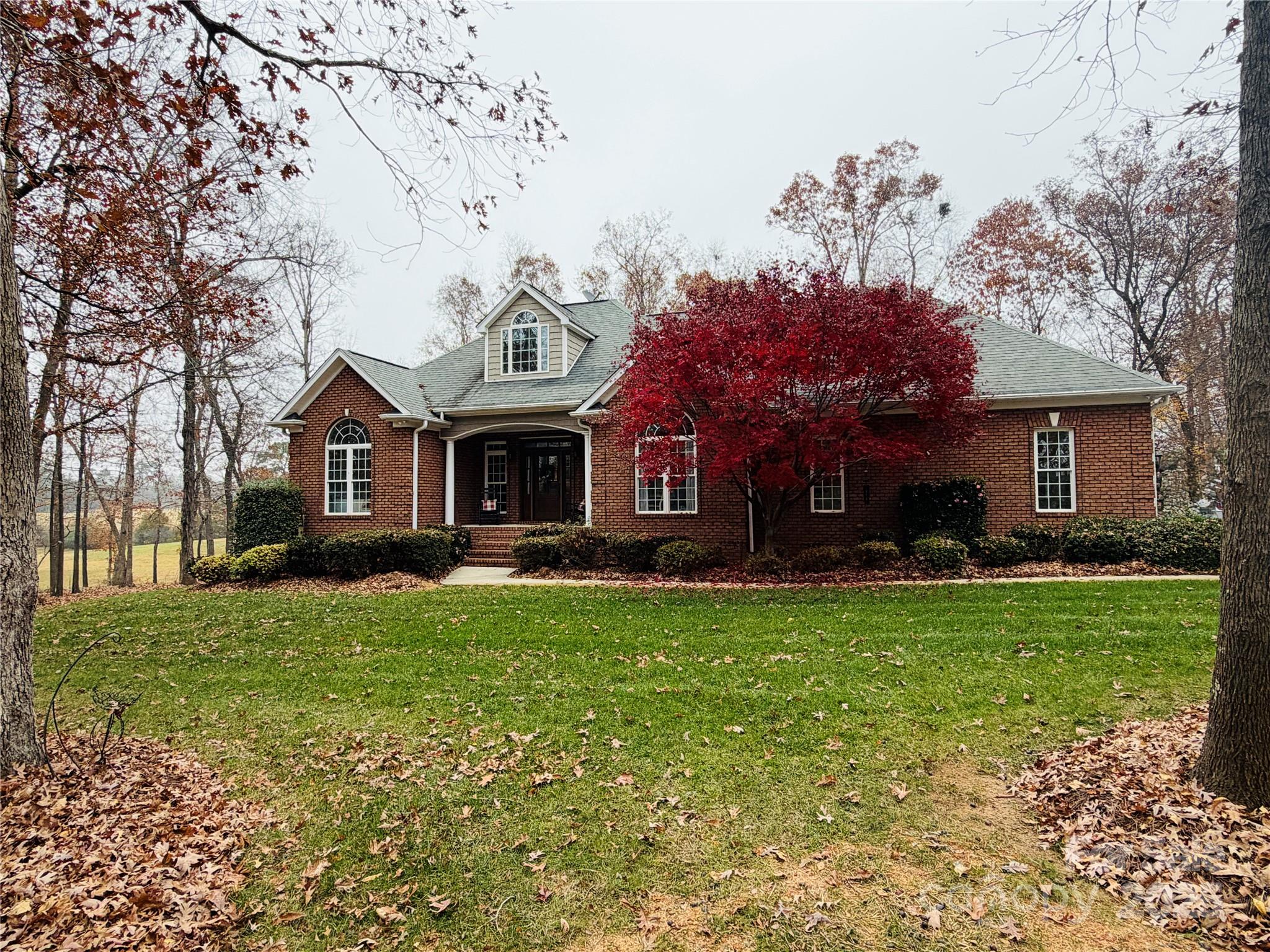 Welcome to your dream home in the heart of Mt. Pleasant! This beautifully designed 2-bedroom, 3-bathroom full brick home offers versatile living options, with multiple rooms that can function as a third or fourth bedroom, a home office, or a playroom.  This home has over 3,000 sq ft nestled on 5.84 acres, which is a perfect blend of wooded tranquility and is ideal for outdoor activities, privacy, and enjoying nature's beauty.  Step inside to a warm and inviting living room highlighted by a stunning stone gas log fireplace and vaulted ceilings. The kitchen features a bar that opens the breakfast nook to the living area, creating a semi-open floor plan with an easy, connected flow. You'll also enjoy a separate formal dining room, perfect for hosting larger gatherings. The home showcases numerous upgrades, new HVAC, beautifully refinished hardwood floors, and a large laundry room with abundant storage, which provides added convenience and organization. The oversized primary bedroom features a customized closet system, while the primary bathroom offers a spacious walk-in shower and garden tub. Enjoy the spacious deck and screened-in porch, perfect for entertaining or relaxing after a long day. The fully finished basement adds exceptional versatility, complete with a second kitchen and generous additional living space.  Atrium doors open to a patio, extending your options for outdoor enjoyment. For car enthusiasts, the impressive 1800 sq ft, detached four-car garage is fully climate-controlled and enhanced with spray insulation and LED lighting for comfort and efficiency. This remarkable space is ideal for storing or working on cars and can function as a workshop or adapt to nearly any need. Just minutes away from downtown Mt. Pleasant, you'll have easy access to a variety of local restaurants, fine dining, a distillery, and shops, ensuring that everything you need is right at your fingertips This one-of-a-kind property combines luxury, privacy, and functionality. Your dream home awaits. Schedule your showing today!