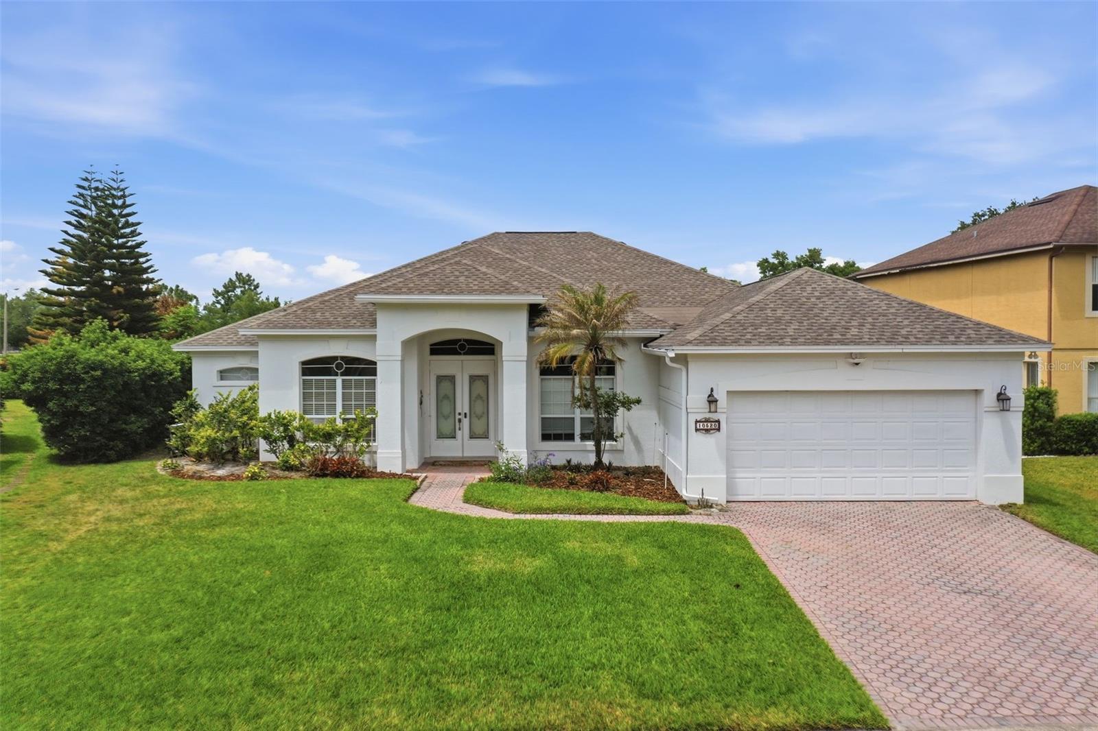 Location, Location, Location. Nestled on a quiet street close to the cul-de-sac in the highly desirable Diamond Cove community, this beautifully updated Dr. Phillips pool home is truly move-in ready. The home features 4 bedrooms, 3 full bathrooms, 2 dining areas, a separate family room, a formal living room, an oversized 2-car garage, and an oversized lot, delivering exceptional space and versatility in a sought-after pool home setting. Freshly painted exterior, interior, pool deck, and entrance door enhance the home’s crisp, modern appeal. Step through the double glass entry doors and immediately notice soaring high ceilings, abundant natural light streaming through expansive windows, and fresh interior paint that create a bright, airy, and spacious feel. The open layout enhances flow throughout the home, while sliding glass doors from both the family room and primary suite open directly to the screened outdoor patio and pool area, creating a seamless indoor and outdoor living experience. The stunning updated kitchen sits at the center of the home, featuring quartz countertops, sleek cabinetry, newer stainless steel appliances, and a brand new quiet Kohler garbage disposal, designed for both everyday living and entertaining. The spacious primary suite serves as a private retreat with dual walk-in closets and a spa-style bathroom featuring a tiled walk-in shower, double vanity, garden tub, and private water closet. Ceiling fans are installed throughout most rooms for added comfort and efficiency. The secondary bedrooms are well arranged, including a Jack and Jill bathroom between the second and third bedrooms, plus a separate full bathroom near the fourth bedroom, ideal for guests or flexible living needs, and have convenient access to the pool area as a dedicated pool bath. Step outside to a private backyard oasis where a resurfaced and retiled pool (2021) sits on an oversized lot, surrounded by lush natural greenery, creating a peaceful and secluded setting perfect for relaxing or entertaining. The pool lighting creates an evening extravaganza, beautifully illuminating the screened pool patio and transforming the backyard into a stunning nighttime retreat. A termite bond is in place for added peace of mind, with regular inspections recommended. Recent updates include a 2023 HVAC system and a 2020 roof, providing added confidence for future homeowners. The community features a pool, tennis courts, walking trails, and a lakeside pier. Nearby, Dr. Phillips Lakeside Community Park offers playgrounds, splash zones, basketball, baseball, soccer fields, a dog park, and picnic pavilions overlooking Sand Lake. Conveniently located near Restaurant Row, world-class golf, Disney, Universal, International Drive, Whole Foods, Trader Joe's, Sprouts, Publix, HomeGoods, the Dr. Phillips Center for the Performing Arts, and with easy access to Orlando International Airport, the Space Coast, and Florida's east and west coast beaches. Experience the best of Florida living in a quiet, highly sought-after neighborhood while staying just minutes from the excitement of Orlando. Homes like this in Dr. Phillips move fast; do not wait. Make this dream Florida lifestyle yours today.