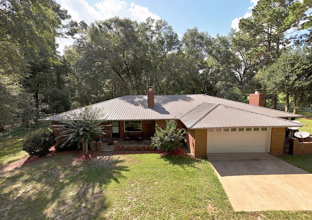 This Boston home has it all, but the land is what you will remember.  Over 9+ acres of woods & cleared property with plenty of wildlife that comes to visit in the backyard.  Located in the sought after community of Boston, Ga., this ranch is 2833 square feet that combines room for just about everything.  An oversized primary bedroom suite with sitting/tv area overlooking the sunroom & backyard along with walk-in closet and spacious bath. Enjoy the family room & fireplace that opens up to the dining room and large kitchen that has an abundance of cabinet space with stainless appliances. The roomy laundry room could double as more storage, canning room or even add 1/2 bath. 2 bedrooms are on the opposite side of the home from the primary with a bath and bonus room.  Mancave to watch the big game, theater room or bonus room that could double as a home gym is just an added extra. This home is not visible from the road and has it's very own private drive. The plus - you are minutes away from Thomasville, Ga for shopping, dining and all that this area has to offer. Ready to see it for yourself?  Call today & make your appointment.