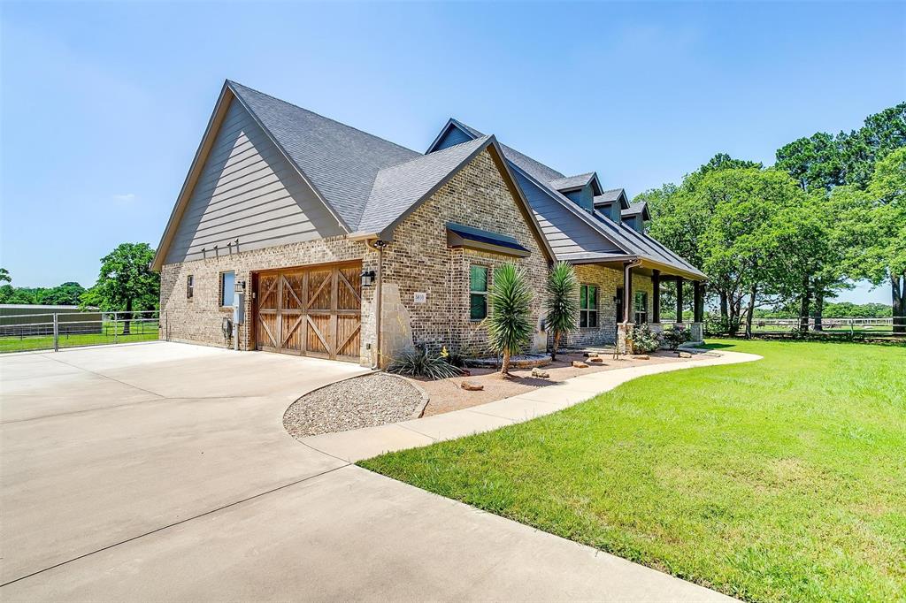 Experience peaceful country living at its finest in this charming 4-bedroom, 3.5-bathroom home nestled on 2 acres just outside the city limits located in Mansfield ISD. All bedrooms are conveniently located on the first floor, with concrete flooring throughout, providing durability and easy maintenance. Upstairs, a cozy game room and bonus room await, adorned with plush carpeting for added comfort.This property offers the perfect blend of tranquility and convenience, with ample outdoor space for entertaining and enjoying the surrounding natural beauty. Embrace the rural lifestyle with mature trees dotting the landscape and plenty of room for outdoor activities. For those with a passion for farming or equestrian pursuits, this home is a dream come true. Bring livestock or chickens and make use of the few stalls and a 30x50 workshop complete with electric and a full bathroom. Whether you're seeking a peaceful retreat or a place to pursue your country living, this property has it all.