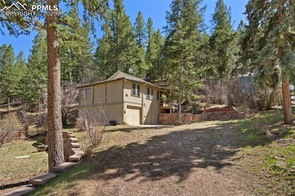 Nestled among the pines in beautiful Cascade, this move-in ready home offers the perfect blend of mountain serenity and modern comfort. Set on a pretty, wooded lot, the property features brand new flooring throughout and fresh interior paint, creating a clean, inviting atmosphere from the moment you step inside. The spacious main level welcomes you with abundant natural light, while the lower level offers a large unfinished storage room—ideal for a home gym, workshop, or future expansion—and includes laundry facilities for added convenience.

An attached garage provides secure parking and additional storage, and the surrounding landscape offers a peaceful, natural setting with mature trees and room to explore. Whether you're relaxing at home or heading out for adventure, the location can't be beat—just minutes from Woodland Park, downtown Colorado Springs, and all the beauty and recreation of the mountains. Enjoy easy access to hiking, biking, skiing, and more, all while tucked away in a quiet, charming mountain community.

The home has been pre-inspected, and is ready for its next chapter. Whether you're looking for a full-time residence, weekend getaway, or investment opportunity, 9375 Ute Rd delivers on location, value, and lifestyle. Don't miss this opportunity to own a piece of Colorado's mountain magic—schedule your showing today!