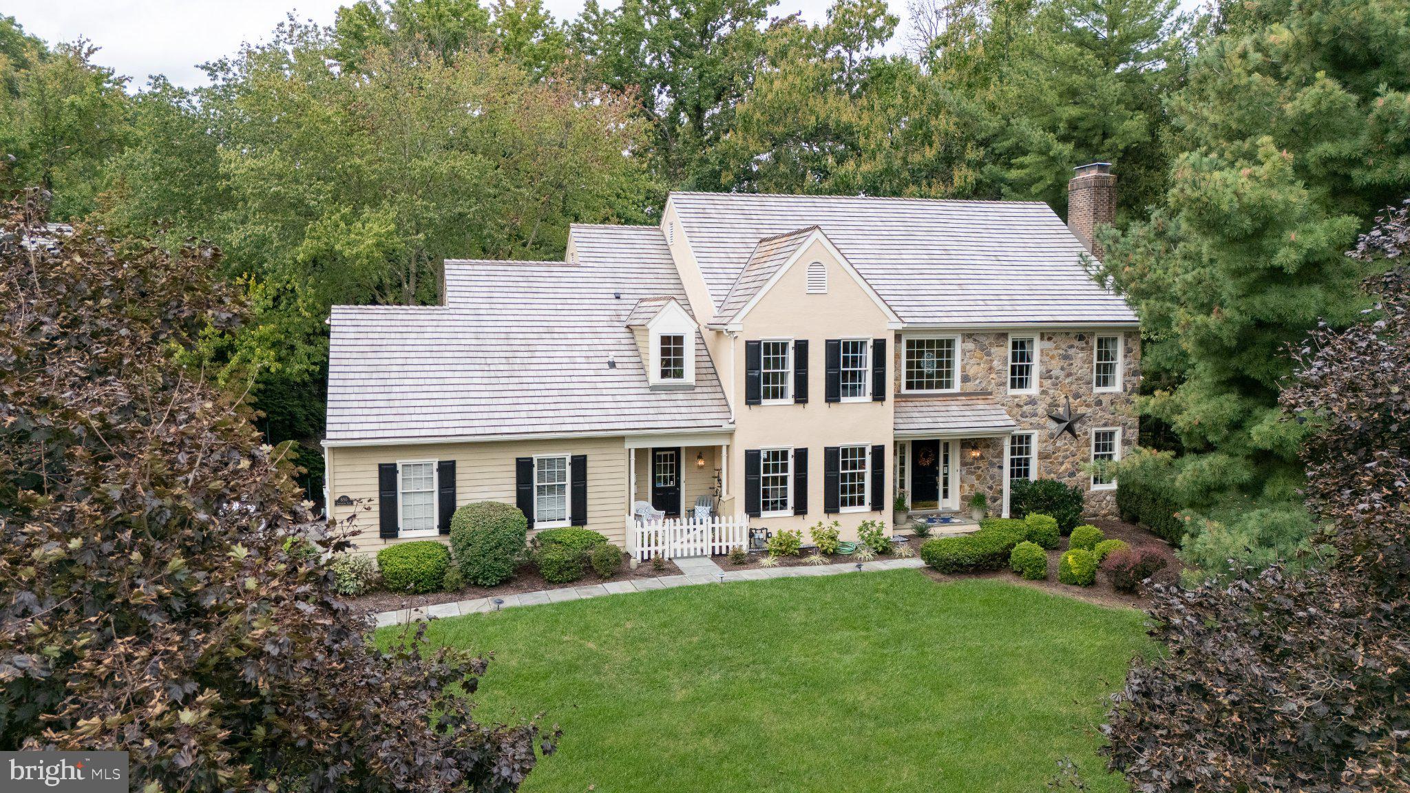 Welcome to 850 Springbank Lane, a wonderful opportunity to own a classic center hall Colonial featuring a geothermal HVAC system, 4 fireplaces, a dramatic 2-story family room, finished au pair/in-law suite and a fenced rear yard in the coveted Avonwood neighborhood of Wayne. Centrally located in the top-ranked Tredyffrin-Easttown School District, this is a rare opportunity to own a classic home in an established neighborhood in one of the Main Line’s most desirable locations. The gracious center entrance hall features a curved staircase and opens to the spacious living room, highlighted by a fireplace with marble surround and Colonial mantel. French doors lead to a perfectly situated home office, featuring its own fireplace with brick hearth and a wall of built-in bookshelves. To the left of the entrance hall is the formal dining room with chair rail and crown molding, the ideal setting for family gatherings and holiday celebrations. The heart of the home is the fabulous eat-in kitchen, featuring a separate dining area with a vaulted ceiling, 2 solar-powered Velux skylights, Palladian window and a doorway to the side brick patio. The kitchen offers a granite-topped center island with pendant lighting, granite countertops, new subway tile backsplash, raised-panel cabinetry, a large pantry and stainless steel appliances. The kitchen opens directly to the spectacular family room, featuring a soaring 2-story ceiling, fireplace, walls of windows, and built-in cabinetry and shelving. Two glass doors open to the expansive deck overlooking the fenced rear grounds—the ideal spot for relaxing, entertaining, grilling and dining al fresco.  A laundry room/mudroom provides access to the 2-car garage as well as a doorway to the quaint covered front porch. A nicely situated powder room completes the 1st floor of this very special home. The 2nd floor features a large hallway overlooking the dramatic family room below. The spacious owner’s suite offers a tray ceiling, 2 large walk-in closets, a fireplace and a sumptuous owner’s bathroom with a vaulted ceiling, a solar-powered Velux skylight, separate vanities, jetted soaking tub, and a tiled shower. Three additional generously sized bedrooms, each offering excellent closet space, are serviced by a tiled hall bathroom. The lower level, with its uncommonly high ceilings, is home to a nicely finished au pair/in-law suite, offering a finished living area, bedroom and full bathroom—also an ideal setup for a returning child, extended family or guests. A massive unfinished storage room provides tremendous storage and endless possibilities. Additional highlights include a highly efficient geothermal HVAC system offering exceptionally low utility costs and 3 solar-powered Velux skylights designed to help reduce heat.  A new (2025) cedar roof, hardwood flooring, recessed lighting, 4 fireplaces, high ceilings and so much more all come together to make 850 Springbank Lane a very special place to call home. Ideally located close to Valley Forge National Park, the Chester Valley Trail, King of Prussia Town Center, Gateway Shopping Center, and the shops, trains and restaurants of the Main Line, this is a rare opportunity to own a classic home in an established neighborhood in the top-ranked Tredyffrin-Easttown School District. Your search is over. Welcome home!