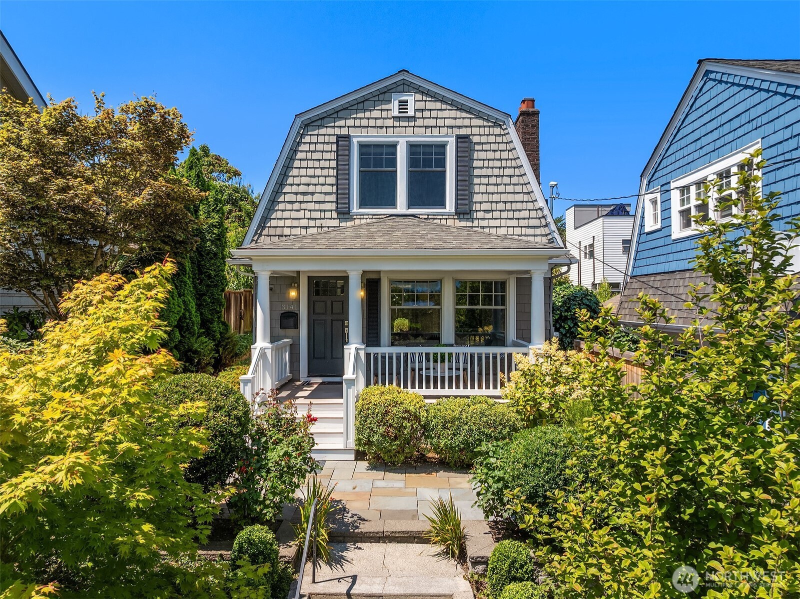 Timeless Dutch Colonial in coveted Portage Bay, where historic character meets modern, move-in-ready living on a quiet residential street just minutes from Downtown, South Lake Union, and University District. Elevated above the street with beautifully manicured landscaping, the home welcomes with exceptional curb appeal, abundant natural light, rich fir floors, expansive windows & a fireplace flanked by custom built-ins. Open floor plan seamlessly connects the living, dining & updated kitchen, featuring white quartz counters, Viking range, Bosch & KitchenAid appliances. French doors open to a private deck & patio for effortless entertaining. Beautifully updated baths include a relaxing Japanese soaking tub. Flexible lower level offers bonus room + abundant storage. Enjoy nearby waterfront parks, scenic trails & one of Seattle's most desirable in-city lifestyles.