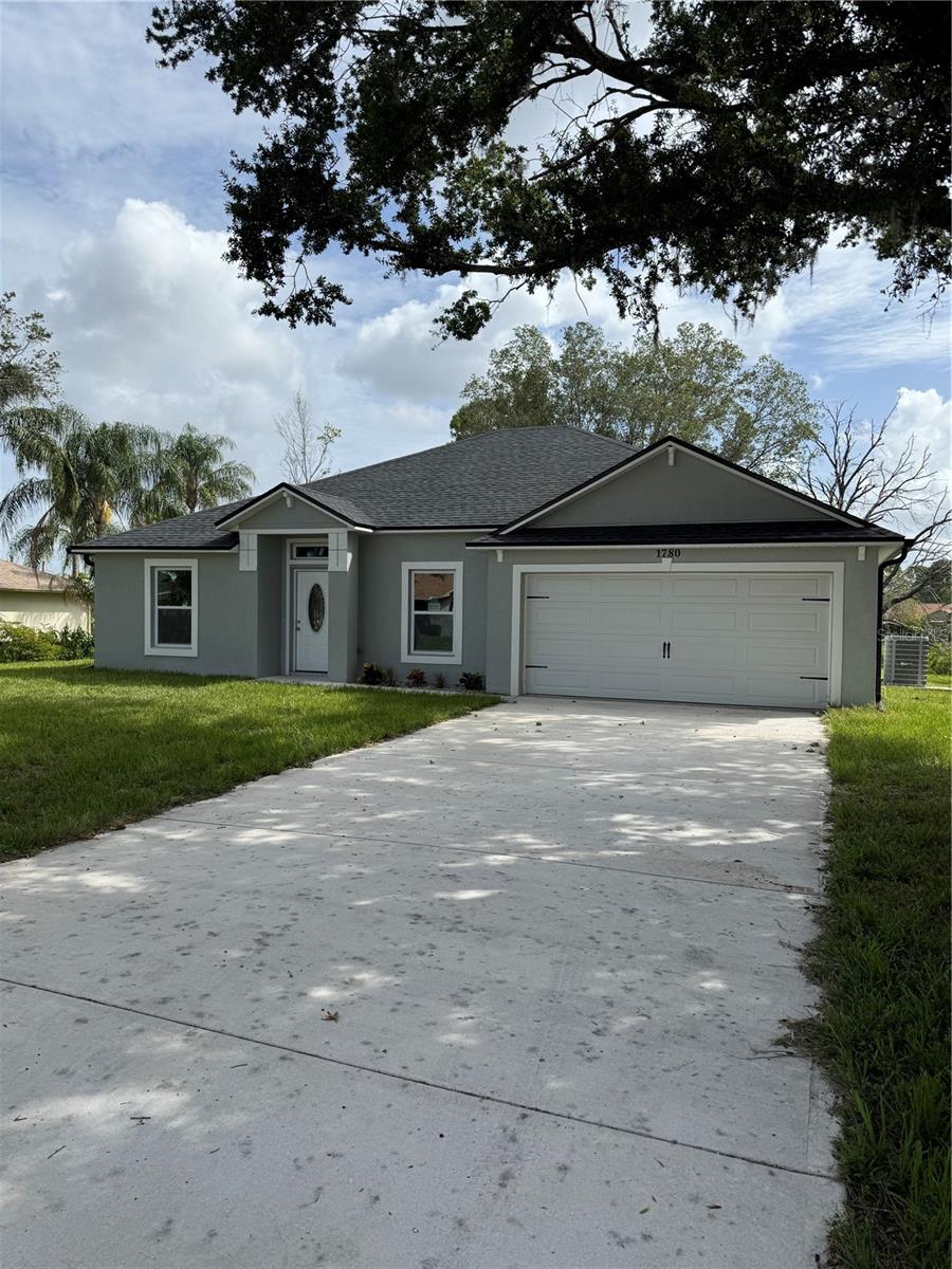 3.99 APR financing available with flex cash. listing agent has details. Brand new waterfront lake home MOVE-IN READY. No HOA. The home offers granite in kitchen and both baths, as well as solid wood cabinetry with 42" kitchen cabinets. There is tile throughout. Home warranty. Home includes 4 bedrooms, 2 bathrooms, 2 car garage. Concrete block home with stucco finish, matching granite kitchen counter tops with full wall backsplash. Granite in both bathrooms. Master has vaulted ceilings, custom tile walk-in shower, upgraded large soaker bathtub, walk-in closet, toilet closet, and double sinks with upgraded faucets in owner's suite. Laundry room is located inside home adjacent to kitchen and master bedroom. Extra storage space included in indoor laundry room. UPGRADED, solid wood cabinetry ESPRESSO color in kitchen and baths. Kitchen cabinets are self-closing/ soft close. SS fridge, glass top range, microwave & dishwasher. Recessed lighting and chandelier in kitchen and foyer with tear-drop lighting at bar counter. Eat-in space in kitchen plus breakfast bar. Swing doors throughout. Rear sliding glass door. Upgraded 5.5 base trim throughout. Upgraded energy-efficient windows. Home qualifies for both home-owners insurance and energy discounts. Safe room. Large backyard. Brand New Home! Lifetime shingle warranty with GAF manufacturer. All measurements are approximate. Amazing rear view on Lake Lucerne