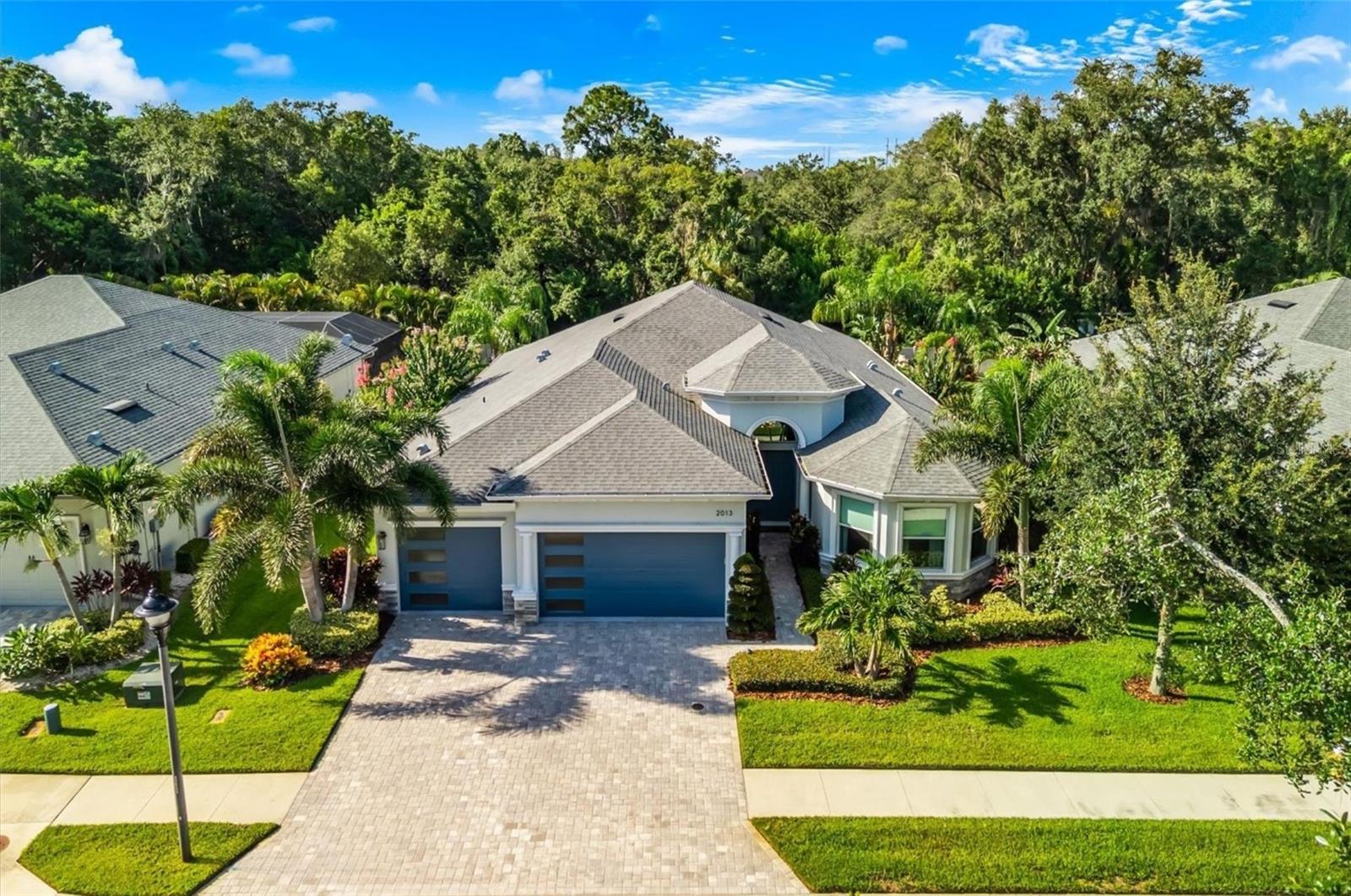 Thoughtfully designed and extensively enhanced beyond its original construction, this beautifully appointed Gulfwind Homes residence blends timeless architecture, carefully curated finishes, and resort-inspired outdoor living into a home that feels as impressive today as the day it was completed. Built in 2019, the 4-bedroom, 4-bath home offers 3,082 square feet of refined living space and is positioned on one of a limited number of premium estate homesites originally designated by the builder. With no direct rear neighbors, an elevated setting within the gated community of Creekview Estates, and a location on a quiet cul-de-sac, the property offers a wonderful balance of privacy, comfort, and everyday convenience.From the moment you arrive, professionally designed landscaping, custom exterior uplighting, upgraded garage doors, and timeless architectural details create an inviting first impression. Inside, soaring ceilings, abundant natural light, and an open-concept design create comfortable gathering spaces while maintaining an elegant sense of scale. More than $65,000 in builder-selected upgrades serve as the foundation for a home that has been further enhanced with extensive custom improvements, including designer Restoration Hardware lighting valued at approximately $25,000, custom closet systems throughout, custom window treatments with motorized blinds in the primary suite, whole-house audio, an integrated security system, sealed garage flooring, and a tankless natural gas water heater. The thoughtfully designed split-bedroom layout also includes a private in-law suite with its own bedroom and full bath, providing flexibility for guests or multigenerational living.Designed to embrace Florida's year-round indoor-outdoor lifestyle, the backyard unfolds as a private retreat where every detail was intentionally planned. The custom heated saltwater pool and spa serves as the centerpiece, enhanced by illuminated fountain water features, color-changing LED lighting, and an expansive 835-square-foot travertine terrace that invites everything from quiet morning coffee to evenings spent entertaining beneath the stars. The fully equipped outdoor kitchen, outdoor shower, professionally designed landscaping, irrigation system, custom exterior uplighting, integrated speakers throughout the lanai and pool area, vinyl fencing, and removable pool safety enclosure create an outdoor environment that is both functional and beautifully finished.The kitchen is equally well suited for everyday living and entertaining, featuring natural gas cooking, built-in appliances, a convection oven, wine refrigerator, bar refrigerator, generous preparation space, and seamless connection to the main living areas. Hurricane shutters, natural gas utilities, and numerous thoughtful upgrades throughout further reflect the care invested in the home.Conveniently located just minutes from Innisbrook Golf Resort, award-winning Gulf beaches, marinas, parks, shopping, dining, and everyday conveniences, this is an opportunity to enjoy a thoughtfully upgraded residence where quality craftsmanship, carefully selected finishes, and exceptional indoor-outdoor living come together in one remarkable home.