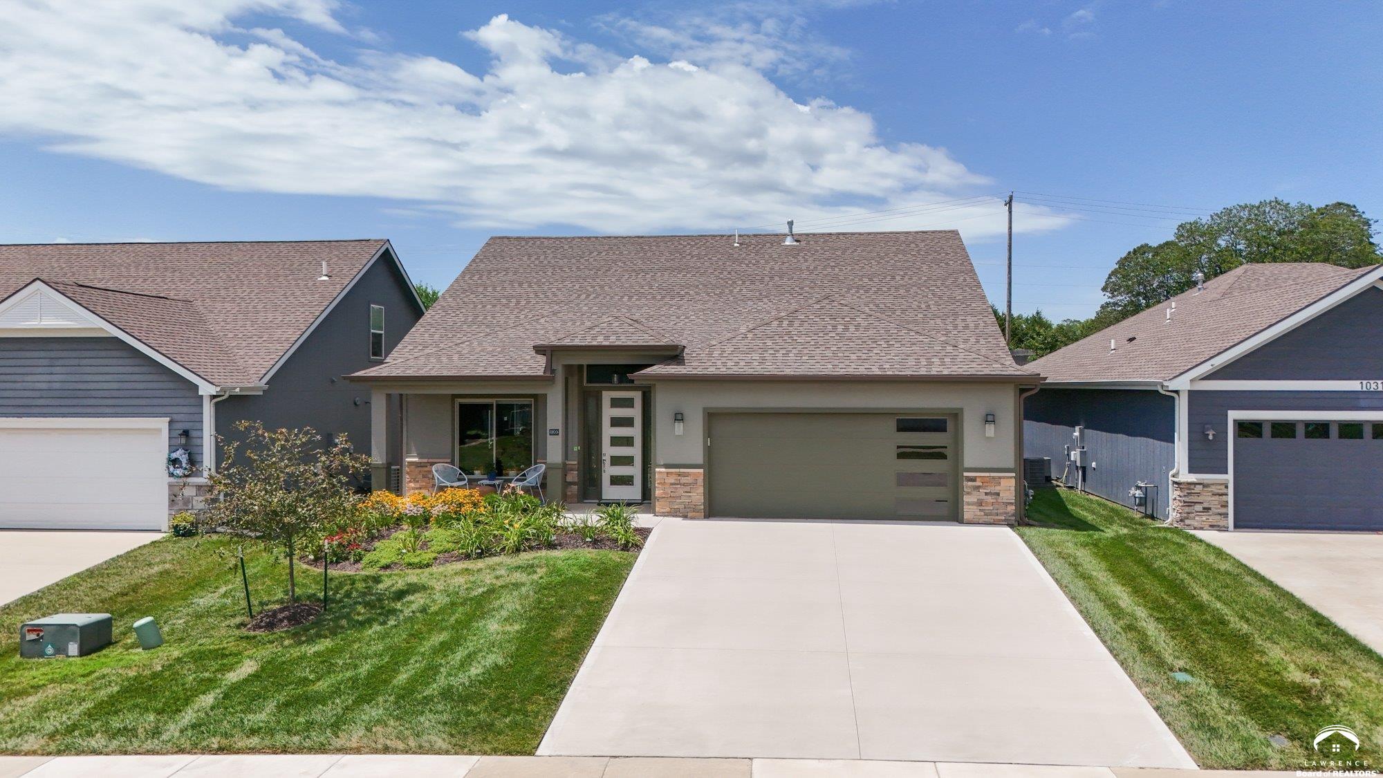 Beautifully designed and move-in ready, this 3-bedroom, 3-bath home in the desirable Langston Hughes community offers the perfect blend of comfort and style. Step inside to a bright open floor plan with soaring ceilings, a cozy fireplace, and expansive windows that bring in natural light. The chef’s kitchen features quartz countertops, custom tile backsplash, stainless steel appliances, and a large island with seating perfect for gatherings. The main-level primary suite is a true retreat with a spa-like ensuite showcasing a soaking tub, oversized walk-in shower with custom tile detail, and double vanities. Upstairs, two generously sized bedrooms share a Jack & Jill bathroom, each with its own large closet. Outside, enjoy beautifully landscaped front and back yards with curated flower beds, full irrigation system, and a spacious patio ideal for outdoor entertaining. The fenced yard, stone retaining wall, and mature plantings provide both beauty and privacy. Built just three years ago, this home combines modern amenities with thoughtful details inside and out. Schedule your private showing today!