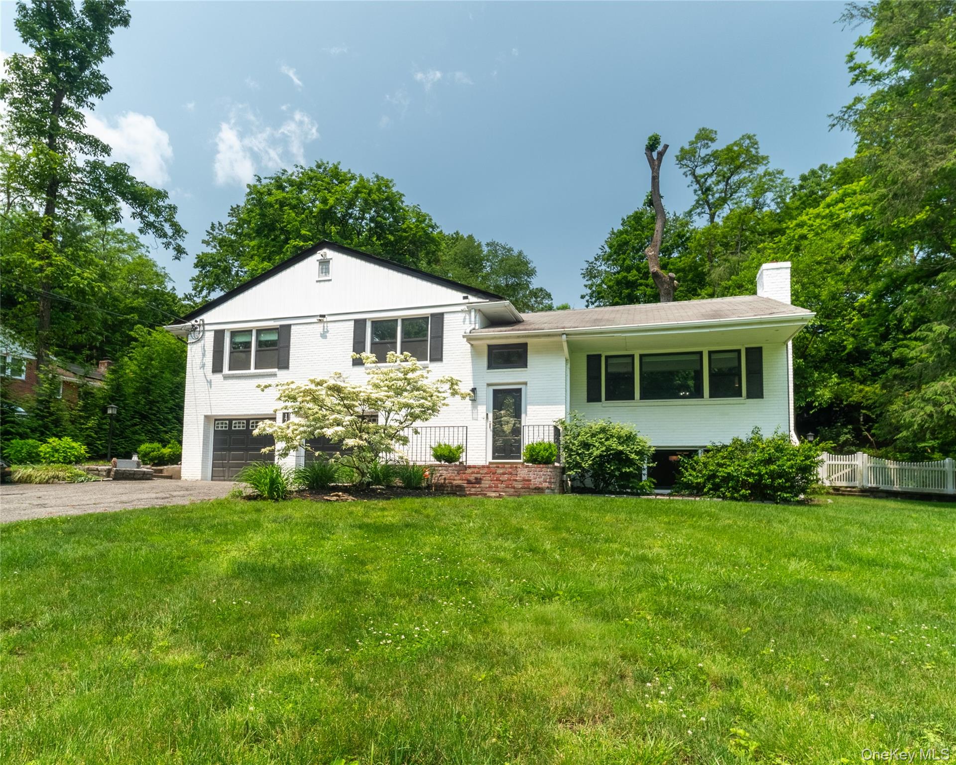 Beautiful home on .83 acre of majestically landscaped Property. Home offers Kitchen/ Dining room combo, living room, primary Bedroom with Ensuite bath
Bedroom, Bedroom Hall bath. Lower level offers family room with gas fireplace and bar great for entertaining, bathroom, laundry and access to two car garage. The exterior white brick with black trim is consistent with the modern style of today. Parking for 4 to 6 cars in driveway. New HVAC, new septic, new electrical.
easy commute to New York City, close to train and major routes, shops and restaurants. (Owner has to relocate near family and will entertain all offers.)