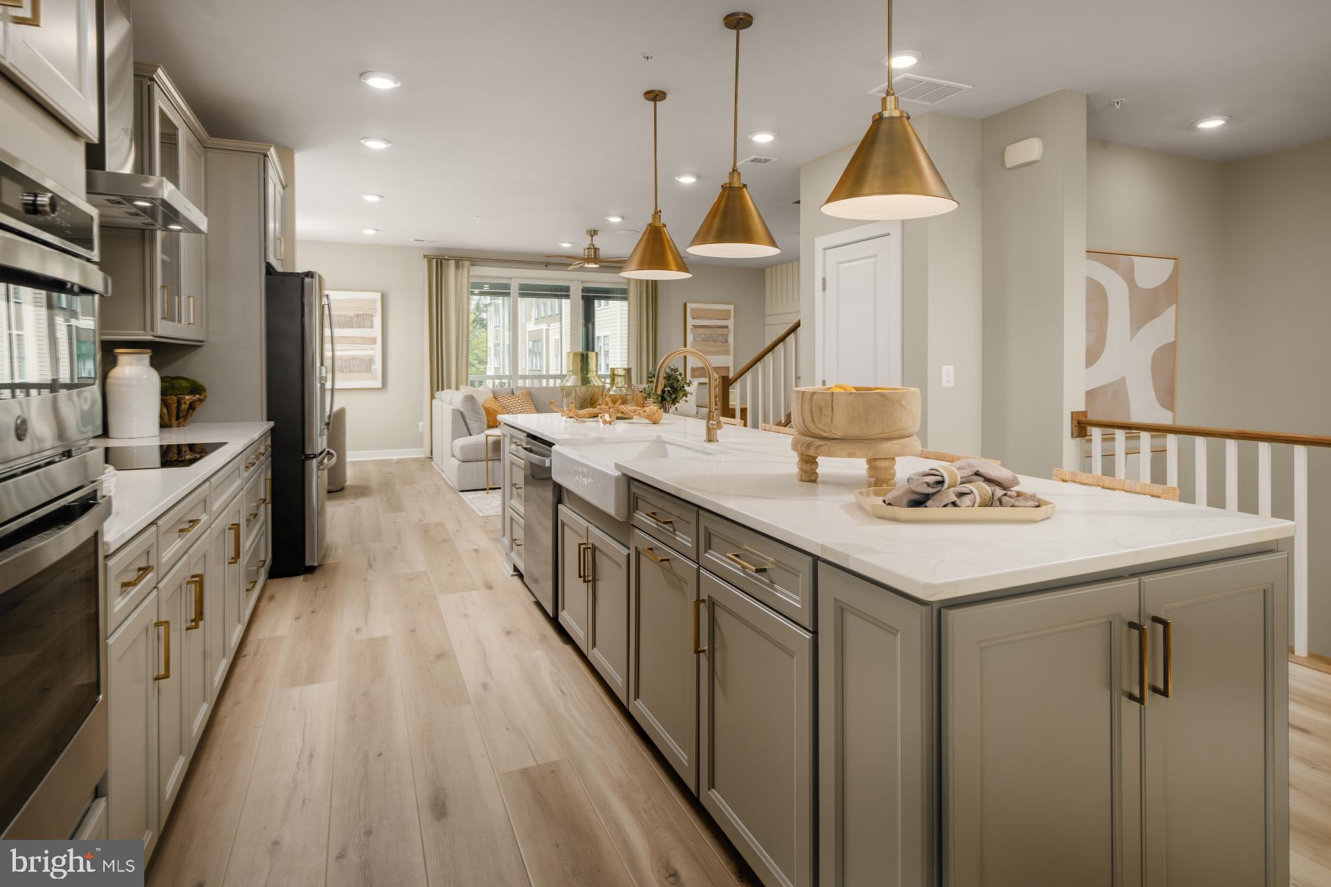 **Up to 30K IN FLEX CASH WITH USE OF APPROVED LENDER AND TITLE! Lower your price, cover your closing costs, or buy your rate down**Summer Delivery! Step inside the Clarendon, where thoughtful design and stylish finishes come together in every room. Enter through the welcoming front door or enjoy the convenience of access through the private rear garage—both leading into the main living level. At the heart of the home, the gourmet kitchen shines with designer pendant lights over the oversized 12 ft. island. An upgraded induction cooktop and walk-in pantry complete this chef-ready space. Just beyond, the dining room flows seamlessly into a spacious great room that opens to a covered lanai, ideal for indoor-outdoor living. Upstairs, the primary suite offers a private retreat with an expansive walk-in closet and a spa-inspired bath featuring a ceramic-tiled walk-in shower with seat, frameless shower door and two shower heads. Two generously sized secondary bedrooms share a full hall bath with dual sink vanity and upgraded ceramic tile. A full-size washer and dryer are conveniently located on this level. Continue up to the impressive rooftop terrace to take in sweeping views of One Loudoun Central Park and Town Center—the perfect spot for morning coffee or evening entertaining.  *Photos may not be of actual home. Photos may be of similar home/floorplan if home is under construction or if this is a base price listing.