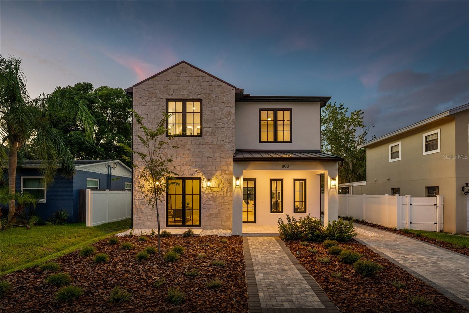 Exquisite new LUIH home in the heart of College Park, just steps from the Edgewater Drive. Upon entry, you are greeted with soaring ceilings, custom millwork, and expansive windows that flood the home with natural light. Every detail has been carefully curated by master designers from the intricate trim work to the designer lighting that highlights each space. The open floor plan unfolds seamlessly, offering both grand entertaining areas and intimate spaces for everyday living. At the center of the home is a chef’s kitchen of unparalleled quality, appointed with gleaming quartz countertops, a dramatic waterfall edge island, and an ensemble of professional-grade Thermador appliances. A custom wet bar with built-in shelving and LED under-cabinet lighting anchors the space, perfect for entertaining in absolute style. The primary suite redefines indulgence, offering a spa-inspired retreat with a freestanding soaking tub, oversized walk-in shower, and a boutique-style closet with generous built-ins featuring LED underlighting. Each secondary bedroom is equally impressive, offering designer finishes and ample closet space. Step outside to discover an outdoor sanctuary designed for year-round enjoyment. A covered lanai frames the resort-style setting, complete with a fully equipped summer kitchen. A rare, detached garage adds convenience and architectural character. Beyond the home itself, the location is unmatched located steps from Edgewater Drive, where walkable charm meets upscale dining, boutique shopping, and cafes. You are also just minutes from the brand-new Packing District which features a 10-restaurant food hall, a new YMCA, and a 45,000 square foot rock climbing facility. Here, you’re not just purchasing a home, you’re securing a lifestyle defined by elegance and timeless luxury. Don’t miss the opportunity to make this stunning home yours.