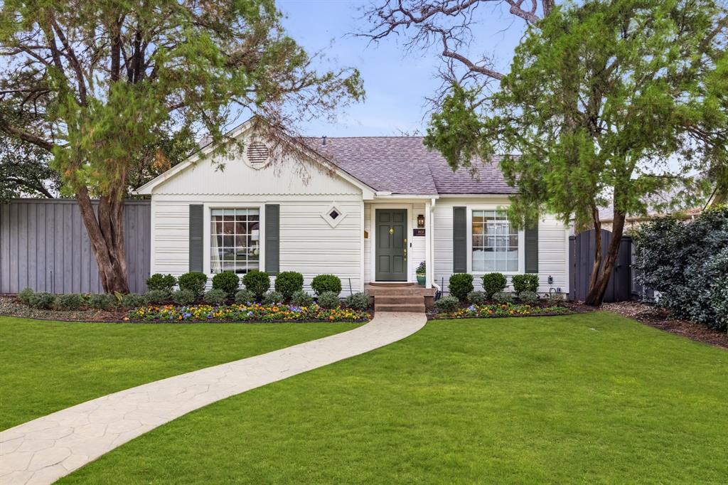 Charming Briarwood cottage with a thoughtful floor plan and inviting indoor-outdoor living. The open kitchen, dining, and living areas offer great flow for everyday living and entertaining. The kitchen features quartzite countertops, dual ovens, a gas range, a pantry, and custom cabinetry, all overlooking a private side courtyard that brings in great natural light. The primary suite includes two walk-in closets and a well-appointed bath with marble countertops, dual vanities, and a separate makeup area. Two additional bedrooms share an updated hall bath. At the rear of the home, a spacious family room with a full bar and a third full bath opens to the backyard, providing a comfortable secondary living space. The backyard features a large wood deck, a fully turfed yard, and covered parking with an electric gate. Recent improvements by the current owners include a new roof, front yard landscaping, sprinkler system, crawl space encapsulation, and replacement of one HVAC unit. Ideally located in Briarwood with convenient access to Inwood Village, the Park Cities, and Dallas’ best shopping and dining.