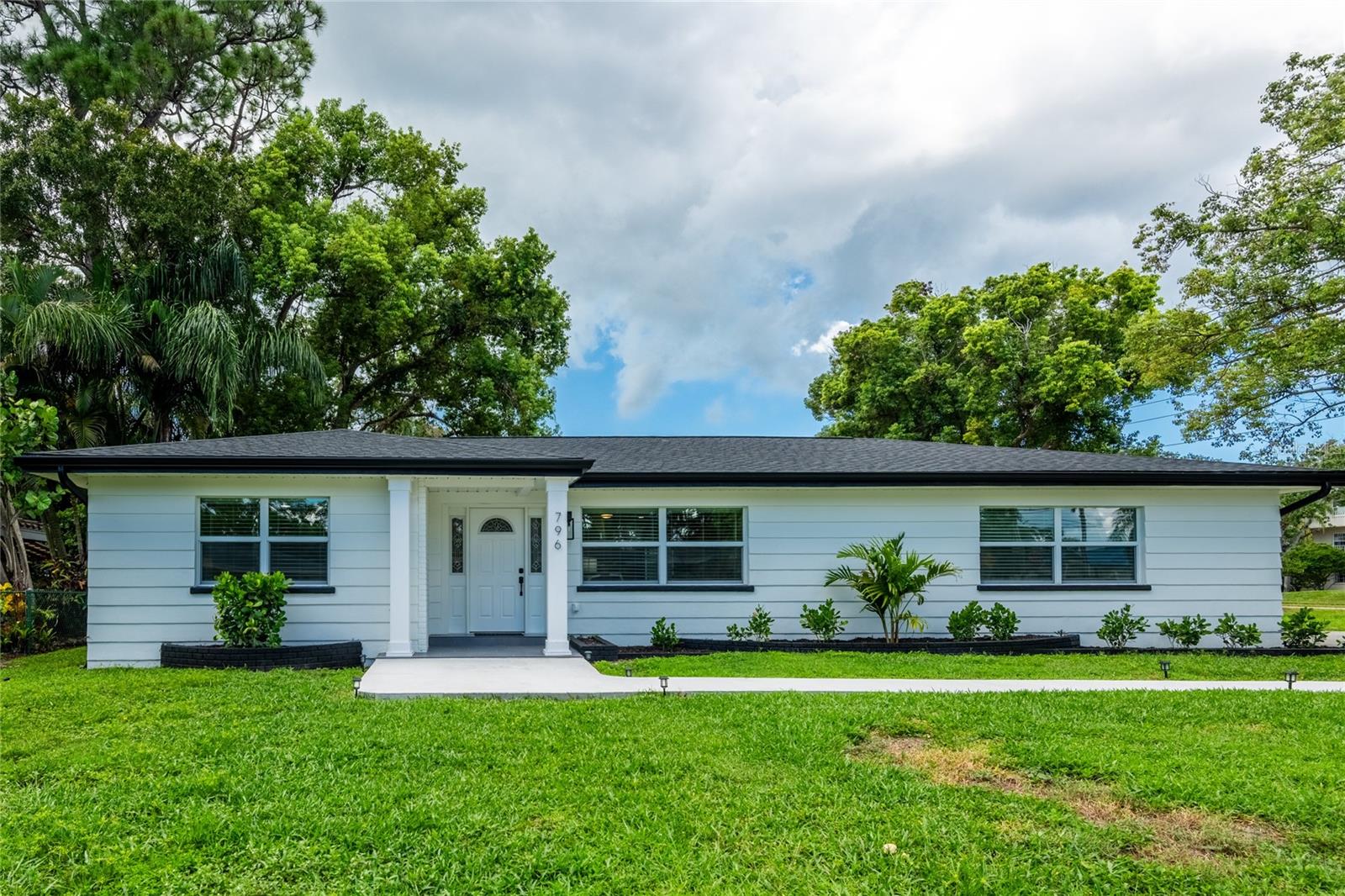 Welcome to 796 Pinewood Drive in desirable Dunedin, Florida! This beautifully renovated 3 bed 2 bath home offers modern style, quality finishes, and extensive upgrades from top to bottom. More than just a cosmetic renovation, this home has undergone a comprehensive transformation featuring a NEW ROOF, NEW HVAC SYSTEM, ALL NEW HURRICANE-RATED WINDOWS, NEW PVC DRAIN LINES, NEW PEX WATER LINES, NEW TANKLESS HOT WATER HEATER, NEW ELECTRICAL SERVICE WITH PANEL, and ALL NEW ELECTRICAL WIRING. The interior has been completely renovated throughout with a fresh, modern design, creating a truly move-in-ready home. All work was permitted and completed by licensed and insured contractors, providing added confidence and peace of mind for the new owner. Enjoy the benefits of a beautifully updated home with all major systems and components already replaced, while still getting the character and convenience of an established Dunedin neighborhood. Ideally located just minutes from vibrant Downtown Dunedin, you'll have easy access to local restaurants, breweries, shops, waterfront parks, the Pinellas Trail, and everything that makes Dunedin one of the Tampa Bay area's most desirable communities. Modern, extensively updated, professionally renovated, and close to the heart of Dunedin - 796 Pinewood Drive is ready for its next owner.