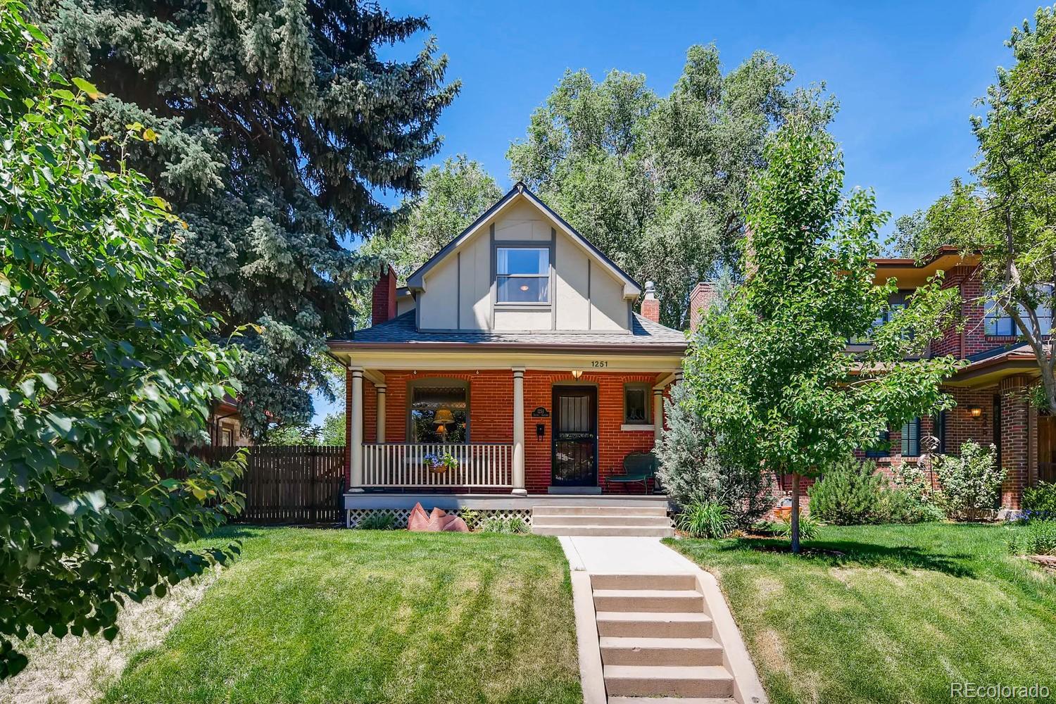 This charming Victorian sits on a rare double elevated lot in Denver’s most coveted neighborhood - East Wash Park - just steps from Old South Gaylord boutiques and restaurants and blocks from the beauty and energy of Washington Park. Filled with character and natural light, the home features a main-floor primary bedroom with adjacent bathroom with heated tile floors, a welcoming great room with a cozy fireplace, and a classic dining room with a bay window overlooking the expansive south yard. The kitchen offers granite countertops, stainless-steel appliances, an extra beverage fridge and original built-ins, while the adjoining sunlit office/sunroom creates an ideal work-from-home retreat. Upstairs, two additional bedrooms and extra closet spaces provide comfort and flexibility, along with the potential for an upper-level deck to capture sunset views. The basement includes ample storage, a laundry room, and space to finish for added living area. The home’s outdoor living stands out with a large backyard and generous side yard, a welcoming front covered porch, a back low maintenance trex deck, and a cozy flagstone patio sitting area ideal for your fire pit, all complemented by the detached two-car garage. With its unbeatable location and architectural character, this home is not only a beautiful place to live but offers strong rental investment opportunity.