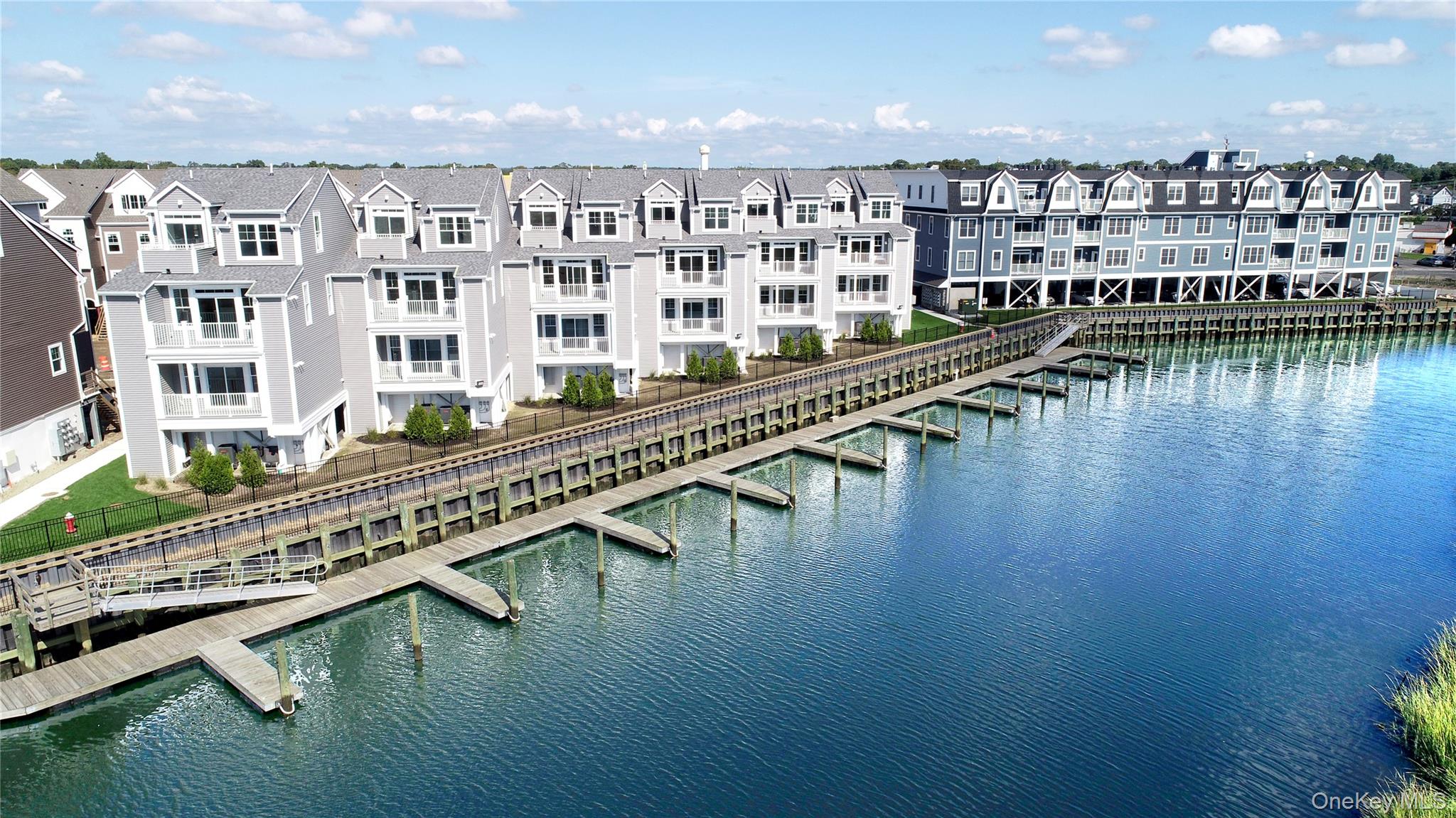 Come and view this well-designed condo suite at Marina Pointe.  The open concept living room, contemporary kitchen with an island and dining area are flooded with natural light. Enjoy a private balcony with water views. The king-sized primary suite has an oversized closet and a large ensuite bath with dual sinks. The spacious second bedroom has easy access to the hall bath which includes a tub. In-unit laundry, stainless steel appliances, covered parking, plenty of storage and included snow removal round out the complete package of this maintenance free home! Make it yours today. Sale may be subject to term & conditions of an offering plan. This property is subject to an existing tax exemption as outlined in the offering plan. Purchaser should independently verify tax information.
