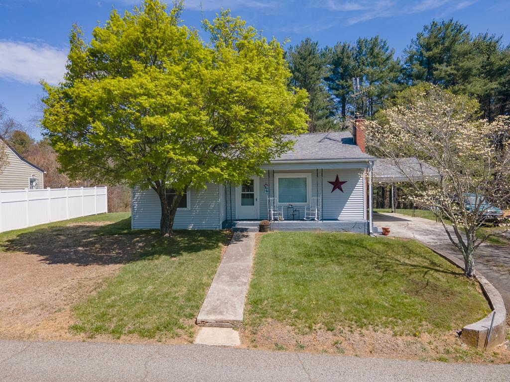 Charming cottage in the heart of Hillsville! Welcome to 210 Sutherland St, where comfort, convenience, and small-town charm come together. Ideally situated just off Main Street, you'll enjoy your peace, while still being within easy walking distance to local favorites like the Hillsville Farmers Market, boutique shops, and dining.  This move-in ready home features newer flooring and is equipped with a forced air oil furnace for efficient heating. Outside, the property truly shines with a beautiful, flat yard—perfect for relaxing or entertaining. The backyard offers lovely flowering trees and a quaint swing set, creating a warm and inviting space for all ages. You'll also appreciate the oversized carport and covered porch, ideal for enjoying those Southwest Virginia evenings.  Connected to town water and sewer, this home offers convenience and reliability. Whether you're a first-time buyer or looking to downsize into something more manageable, this property checks all the boxes.  Located within two hours of several major cities including Roanoke, Winston-Salem, Greensboro, and Bristol, you'll have easy access to larger metro areas while still enjoying the charm of Hillsville living.  Don't miss this opportunity to own a well-maintained home in an incredible location. Call today to schedule your showing—at this price, it won't last long! The home is move-in ready, but is being sold as-is.