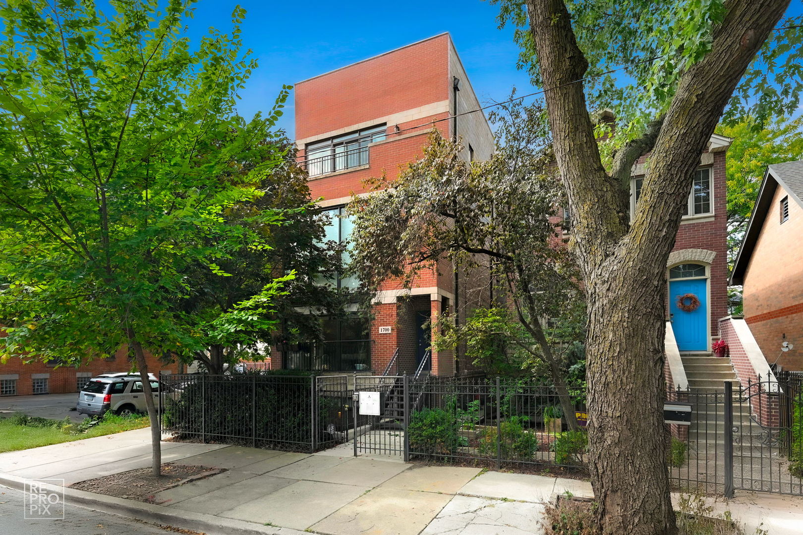 Three-Level Corner Condo with Private Entry. Just four blocks from the Blue Line in Logan Square/West Bucktown, this rare tri-plex lives like a single-family home with incredible natural light and thoughtful design throughout. Floor-to-ceiling, two-story windows illuminate the open living areas, highlighting hardwood floors and modern finishes. The flexible layout offers 3 bedrooms plus a den and 2.5 baths, with a bath on each level for convenience. The professionally designed kitchen features a large island, while spa-like baths, custom closets, and custom window treatments add style and function. Two private outdoor spaces-front and back-extend the living experience and are perfect for entertaining or relaxing. One garage parking space completes this one-of-a-kind home.