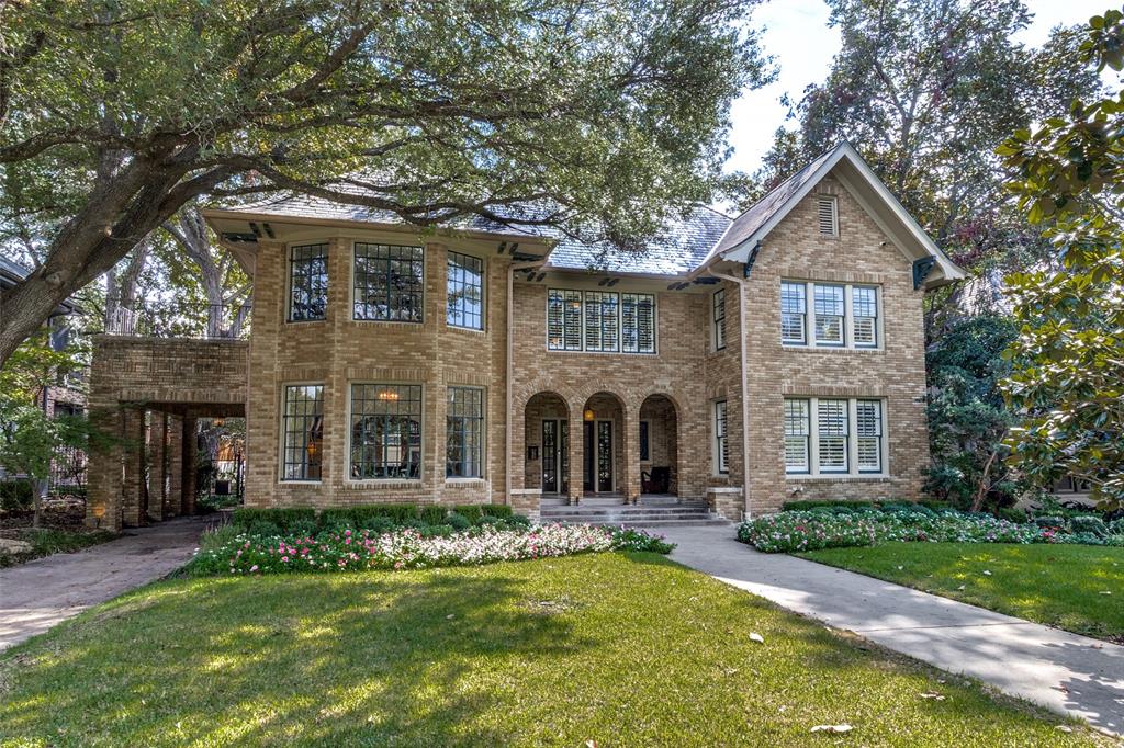 5822 Swiss was designed by architect Marshall Barnett and built by contractor D.A. Barnett in 1924. This eclectic house is considered generally Progressive in design but exhibits understated characteristics of the Tudor style, while its triple-arched entry porch is more reminiscent of Mediterranean homes. Architects of the day called this combined style of architecture “not taking it too straight” because of the overall non adherence to any particular design vernacular.
Three living areas, two dining areas, five bedrooms one of which could be a gym or playroom, and full utility room and remodeled Primary spa like bath are just some of the beautiful living spaces in this home. Completely remodeled for today's living, there is surround sound, recessed lighting, and wooden shutters on all the windows. Original stained glass, paned leaded glass and hardwoods throughout the home. Find the beautiful powder bath well appointed with Hermes wallpaper and a marble sink. The Primary suite has gorgeous marble and tile throughout, a soaking tub and a separate shower with multiple shower heads. There is a screened in sunroom off the main living areas that boasts an electric pipe stove which makes for a cozy outdoor living space.  Almost on a half acre, there is spacious guest quarters over the two car garage with a small kitchen and full bath. The porte cache allows for covered parking as well as the two car garage in back of the home. The location is superior with walkability to shops, dining, grocery and more. Note the large Magnolia in front of the house. It was a gift from original owner to his wife and planted as a sapling over 60 years ago.