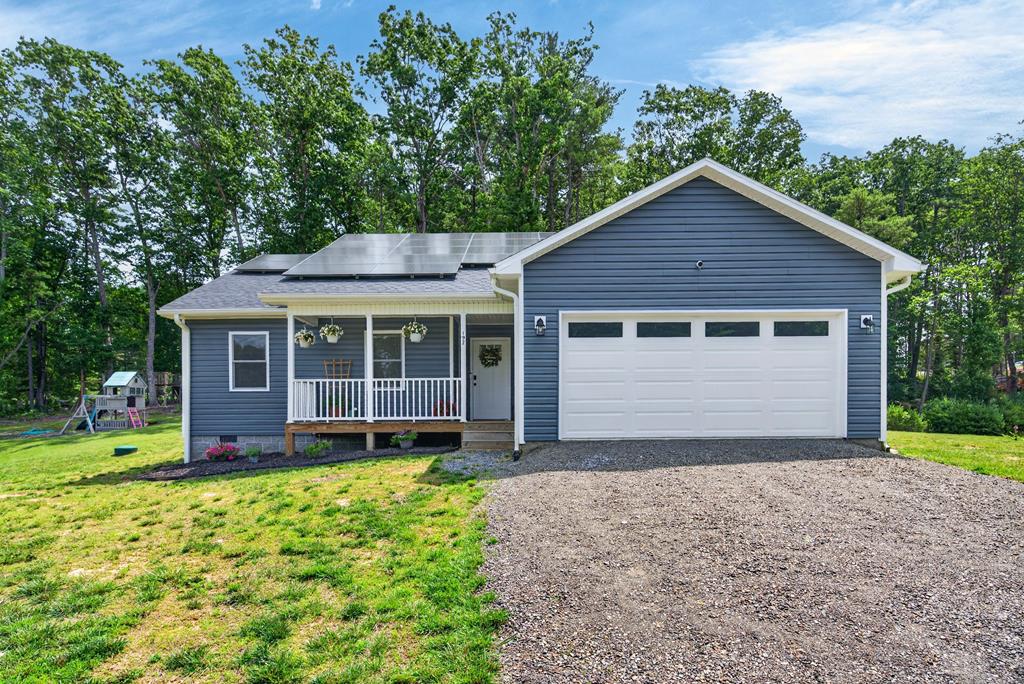Built in 2024, this like-new 3-bedroom, 2-bath ranch offers 1,469 square feet of comfortable one-level living in a peaceful Woodlawn setting between Galax and Hillsville. The bright, open-concept floor plan connects the living room, dining area and kitchen, creating an inviting space for everyday living and entertaining. The kitchen features a large center island, abundant cabinetry, generous counter space and stainless-steel appliances.  All three bedrooms, both full bathrooms and the laundry area are conveniently located on the main level. The primary suite includes a private bath and walk-in closet, while two additional bedrooms provide flexible space for family, guests, a home office or hobbies. The attached two-car garage offers plenty of room for parking, storage, a workshop or home gym.  Relax with your morning coffee on the covered front porch or enjoy grilling, entertaining and the peaceful wooded backdrop from the spacious rear deck. Additional highlights include fiber-optic internet, heat-pump heating and cooling, solar panels, a low-maintenance exterior and no HOA. The refrigerator, dishwasher, microwave, washer and dryer are included, making this home truly move-in ready.  Located in the beautiful Blue Ridge Mountains of Southwest Virginia, this property offers convenient access to shopping, dining, schools, medical services and everyday amenities in Galax and Hillsville. Enjoy nearby outdoor recreation along the New River and New River Trail State Park, scenic drives on the Blue Ridge Parkway, hiking and live music at the Blue Ridge Music Center, and easy access to the I-77 corridor. Whether you are searching for a primary residence, retirement home or low-maintenance mountain getaway, this home offers modern comfort, a peaceful setting and easy access to some of Southwest Virginia's most loved destinations. Schedule your private showing today.