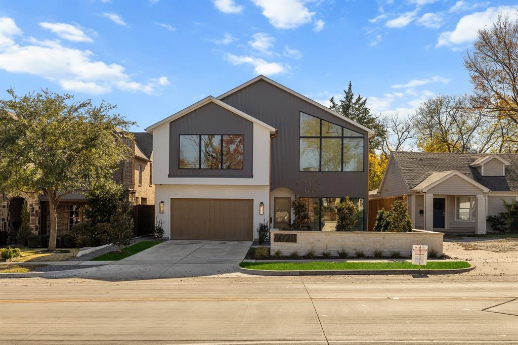 Exceptional new construction in a prime East Dallas location featuring a FULL 1,277 sq. ft. private guest quarters. Guest suite includes a full kitchen, laundry, one and a half baths, private entrance, and dedicated parking—ideal for a home office, guest suite, potential rental use, future pool house, or multigenerational living.The main residence offers a thoughtful floor plan with a study and guest bedroom on the main level and three bedrooms upstairs, along with an upstairs media room featuring custom built-ins and a bar. The oversized primary suite includes a private living area, spa-inspired bath, and two walk-in closets.Designer finishes throughout include white oak hardwood floors, commercial-grade appliances with a built-in Fisher & Paykel paneled refrigerator and Bertazzoni range, quartz countertops, white oak reeded kitchen cabinetry, and a statement vent hood. Architectural archways, natural stone accents, and wood beams add warmth and dimension. All bathrooms are uniquely designed with curated tile selections and custom finishes.Floor-to-ceiling windows provide abundant natural light. Covered patio features a fireplace and wood-accent ceiling, creating an ideal indoor-outdoor living space. Oversized lot offers room for a pool and additional yard space. Quality Kenmare build located minutes from White Rock Lake, dining, shopping, and all East Dallas amenities.