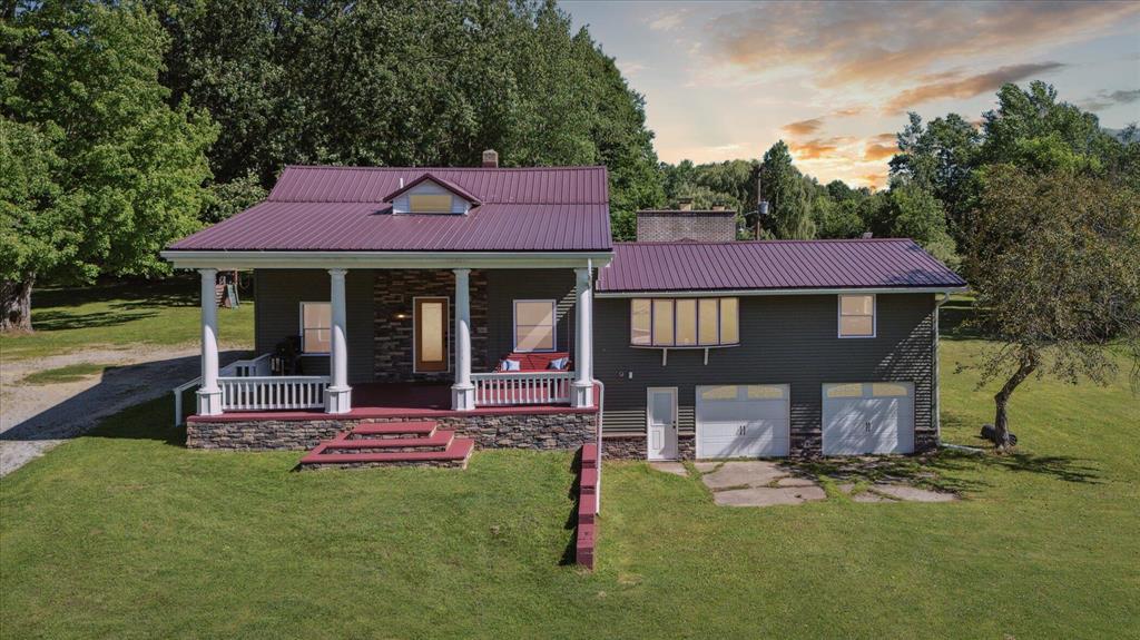 Welcome to 22712 W Gary Road, a fully refreshed 4 BR, 2.5 BA farmhouse-style ranch set on 41.71 acres of prime Michigan countryside. Recent updates (all within the last five years) include new siding, energy-efficient windows (bay window preserved), upgraded exterior doors, a modern gutter system, fresh interior and exterior paint, plus newer flooring in most rooms--blending classic character with turn-key convenience.A sweeping driveway leads to stately white pillars and a generous covered porch--ideal for morning coffee amid songbirds. Inside, 2,917 sq ft of sunlit living space features warm wood trim and polished columns framing a welcoming foyer. The open kitchen awaits your custom island or farmhouse table,while a double-sided stone fireplace with built-in grill anchors all your entertainment gatherings.

Step through French doors onto the expansive entertainer's deck overlooking your stocked pond and rolling fieldsperfect for fishing, hunting, or wildlife watching. The main-floor primary suite offers abundant closet space and serene country vistas. Two upstairs bedrooms, plus an additional main-level bedroom and versatile flex room, complete the residence. Behind the two-car garage, discover a bonus workshop/flex space with its own side entryideal for a studio, root cellar, or workshop.

Endless outdoor recreation and modern updates define this rare acreage estatetruly the best of country living, ready for you.