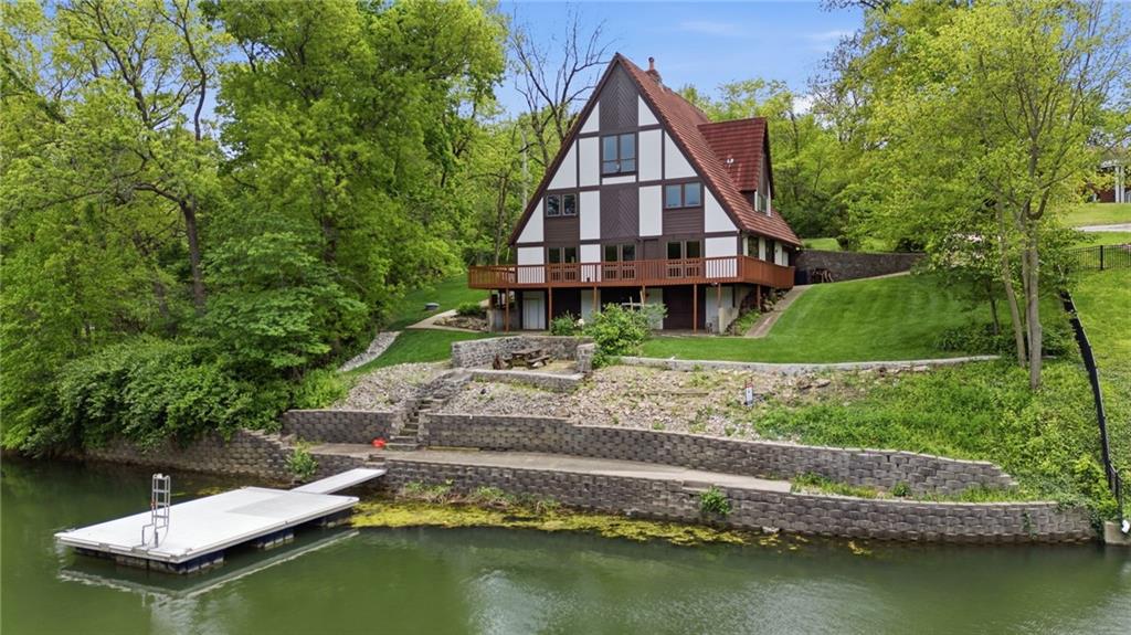Charming historic A-frame lake house offering classic lake life and timeless architectural character. This location cannot be beat. Easy access to shopping, schools, airport, and more, all while being lakefront on one of the most desirable lakes in all of the greater Kansas City area! The views capture the peaceful water natural landscape, a private setting with spectacular swimming, boating, fishing, and other lake activities all in your backyard. A rare opportunity to own a property with 150' of shoreline, deep and desireable water, all in a quiet cove. Better yet, the neighboring property is an access area, ensuring you’ll never have neighbors to the east! It's a piece of authentic lake history in a truly special setting. Come make this 4 bedroom, 3.5 bath home yours. You'll love the character, community, and lifestyle; it's where dreams come true.