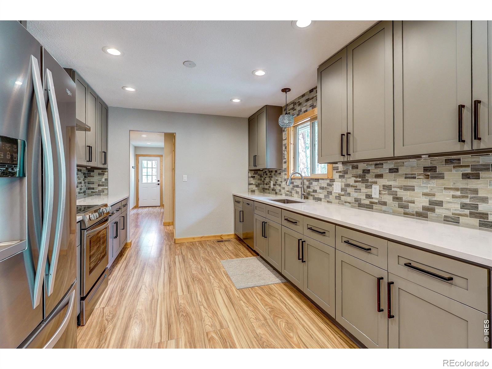 Quiet enclave in the mountains featuring a complete remodel with all stainless kitchen appliances included & washer/dryer. Simple but luxurious feel. Low maintenance flooring, ceiling fans in bedrooms; large and comfortable. Back deck great for winding down at end of the day.Extra long, finished one car garage.Great access to Estes, Lyons and Longmont for shopping & entertainment. Available immediately.