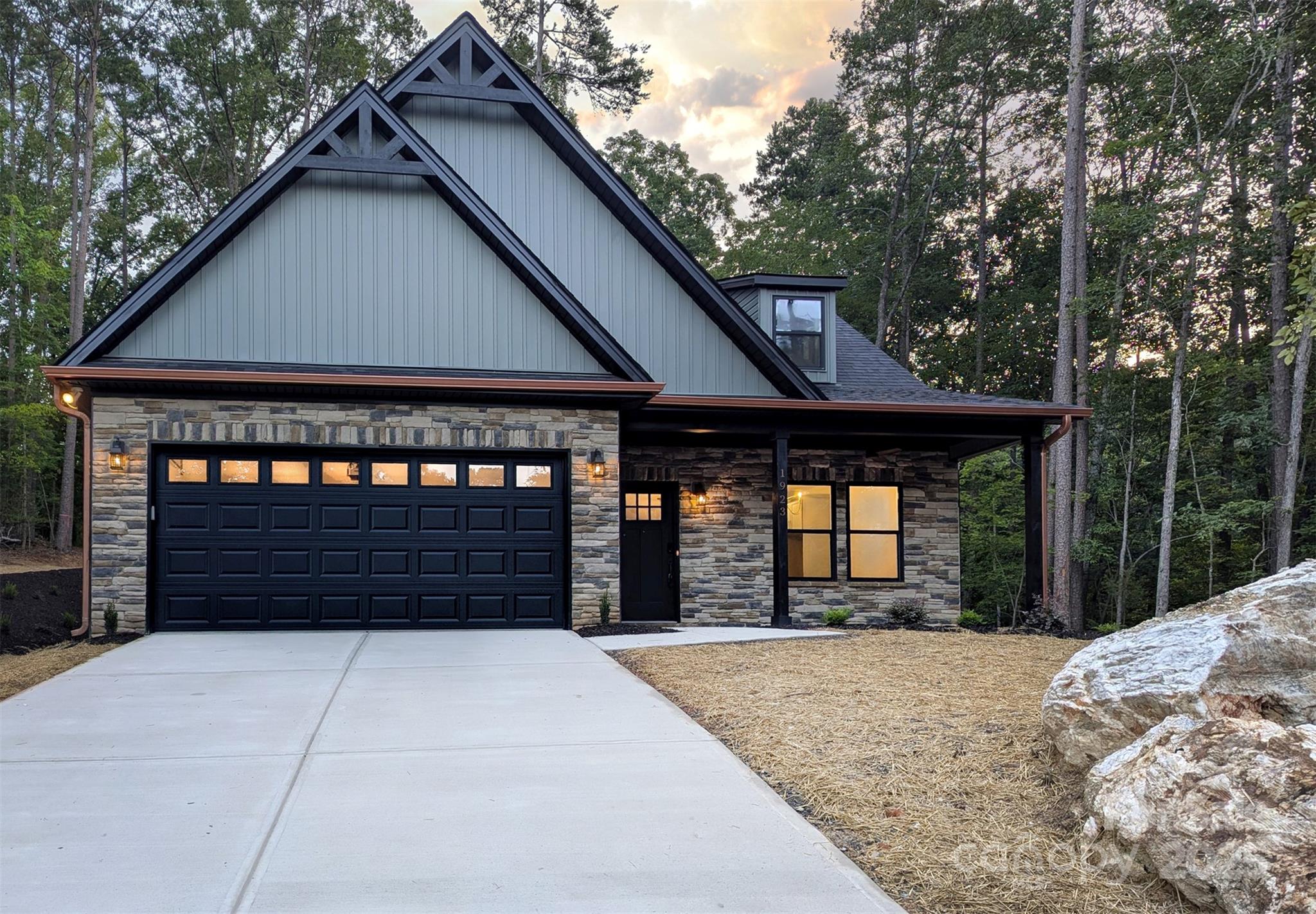 Discover your dream home at 1923 Fairfield Road in Woodrun, Mount Gilead, NC. This charming 3-bedroom, 2.5-bathroom home is ideally situated, neighboring the scenic Uwharrie National Forest while being just approximately one hour from Charlotte. The home provides a generous 1857 total square feet, featuring 1278 square feet on the main level and an additional 579 upstairs. You'll appreciate the convenience of a primary bedroom ensuite and laundry room on the main floor, along with a two-car garage. The home boasts elegant finishes throughout, complemented by a striking stone front and beautiful green siding with distinctive copper gutters.This property provides access to all the fantastic amenities Woodrun has to offer, including a lakefront swimming pool, boat ramp, dry & wet boat storage (waiting list), a welcoming clubhouse, sports court, playground, hiking trails, and peaceful ponds. Don't miss the opportunity to experience Lake Tillery living in this desirable community.