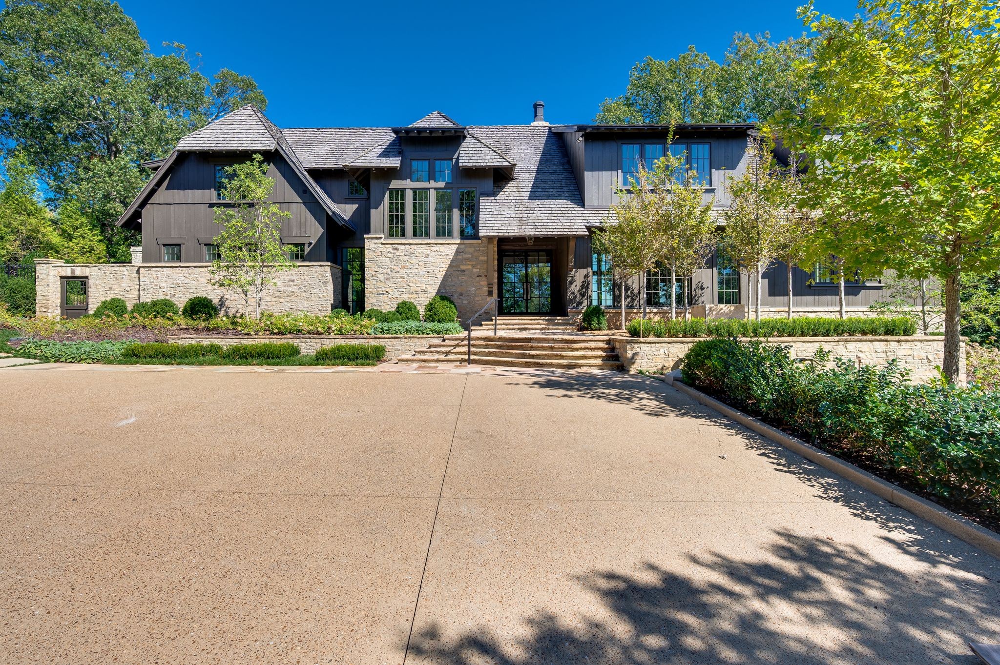 1801 Laurel Ridge Drive is a residence of rare distinction. Perched above the city with a panorama of the Nashville skyline, this estate blends architectural artistry with livable sophistication. Walls of glass invite natural light throughout, framing sweeping horizons and creating an atmosphere that is both powerful and serene. Every finish has been selected with intention, every space designed for both function and beauty. Carefully reimagined by Mark Poe Builders, the home embodies a standard of excellence seldom seen in Tennessee.

The interiors are anchored by the first and only complete Officine Gullo kitchen in the state, a showcase of Italian precision and artistry. The primary suite includes custom closets designed by LA Closet Design, bringing celebrity-level refinement to daily living. A secondary kitchen, private fitness studio with sauna and steam, a 500+ bottle European dine-in wine cellar, walk-in humidor, acoustically enhanced theater or recording studio, and secure safe room extend the home’s offerings without compromise. There is no need to worry about your car collection with three oversized garage bays accommodating six vehicles, with infrastructure to expand capacity to twelve with lift systems. Finally, this home is equipped with a hydraulic elevator servicing all three levels. Each feature is not a separate amenity but an expression of a unified vision.

The exterior is equally purposeful. With every step, you'll find a small piece of beauty brought to life by renowned Landscape Architect, Stephen Hackney. A pergola with a ShadeFX retractable, all-weather roof defines the pool terrace, offering year-round enjoyment. A wood-fired pizza oven, infinity-edge pool and spa, and uninterrupted skyline views create the ease and elegance of a private resort.

1801 Laurel Ridge Drive is more than a home. It is permanence, privacy, and presence in the heart of Nashville.