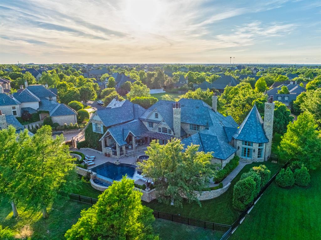 One of Gaillardia’s crown jewels, set on arguably the best lot in the community. This spectacular retreat offers unmatched privacy & one-of-a-kind water views just off Hole 9. The 10,932 sq ft estate blends timeless elegance with modern upgrades. This resort-like property features a 9,479 sq ft main residence & a 1,453 sq ft guest/pool house—ideal for multi-generational living or entertaining. Inside the main home, you’ll find formal & family living areas, two dining spaces, & a one-of-a-kind study with a fireplace, soaring ceilings, & rich architectural details—a true sanctuary of its own. The kitchen stuns with dual islands topped with Blue Louise leather-honed marble countertops, a BlueStar 60” gas range with salamander, Miele appliances—including a built-in refrigerator, coffee maker, & more. Perlick refrigeration & Hoshizaki ice makers support wet bars on both levels. The main home includes 4 bedrooms, 4 full and 2 half baths, a home theater, game room, flex space, 3 gas fireplaces, & laundry rooms both upstairs and downstairs. The primary suite features a spa-like bathroom & a luxurious closet with mirrored doors & Carrara marble counters throughout. Escape into the backyard oasis with an infinity-edge pool/spa & a fully equipped outdoor kitchen. The guest house, with its coastal touches, features a full kitchen, 2 bedrooms, and 2 full baths—perfect for guests or extended stays. A third full bath and laundry area are located below, serving as a convenient pool bath. Car enthusiasts will appreciate the 7-car garage, all with epoxy floors and extensive built-in cabinetry. A new Crestron smart home system controls the property’s audio/visual, lighting, security, access, climate, & pool features. Additional features include new mechanicals and updated appliances, along with a whole house generator. A rare opportunity to own one of Oklahoma City's finest estates—an iconic property never before offered to the market.