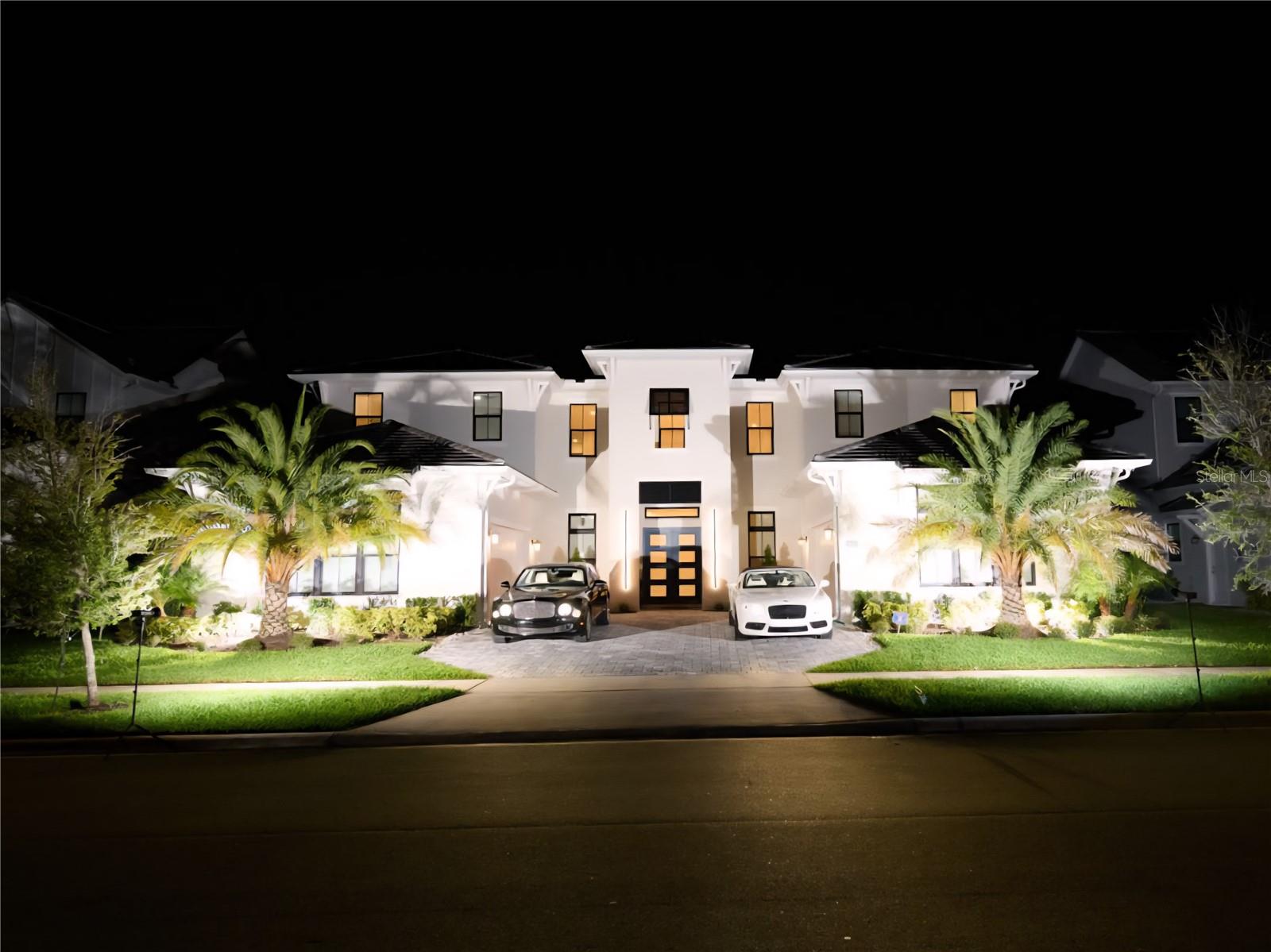 Welcome to The Varen, by Toll Brothers in Lake Nona, a breathtaking 6-bedroom, 6.5-bath luxury residence, 2 offices, loft, bonus room, and impressive POOL, offering 6,672 square feet of elegant living space designed for both comfort and sophistication. A welcoming covered porch and impressive double-door entry open into a dramatic two-story foyer and soaring great room with expansive views of the oversized covered lanai and private forest backdrop. Built with first and second floor block construction and a durable concrete tile roof, this residence blends timeless design with enduring quality. The gourmet kitchen is a true centerpiece, featuring a bright casual dining area, oversized center island with breakfast bar, abundant counter and cabinet space, a walk-in pantry, and a thoughtfully designed workspace off the kitchen. The magnificent primary suite offers a serene retreat with dual walk-in closets and a spa-inspired bath complete with dual vanities, a large soaking tub, a luxe shower with seat, and a private water closet. Upstairs, a spacious loft anchors the secondary bedrooms, two with private baths and one with a shared hall bath, providing both comfort and privacy. Additional highlights include a desirable first-floor guest suite with private bath, a versatile office off the foyer, convenient powder room, centrally located laundry, and abundant storage and solid wood doors throughout.
This extraordinary home has been enhanced with over a million dollars in luxury upgrades that elevate both lifestyle and design. The chef’s kitchen boasts stacked shaker cabinetry with glass inlays, a $13K built-in JennAir refrigerator with extended warranty, a commercial-grade gas stove and oven with custom hood, a built-in coffee and cappuccino machine, and an under-counter wine refrigerator, all anchored by a wrapped center island perfect for entertaining. The laundry room continues the theme of refinement with custom cabinetry, upgraded tile, and a luxury washer and dryer.
Outdoors, a true resort-inspired oasis awaits. A custom-designed pool with retaining walls, valued at $275,000, is framed by a two-story screened enclosure and enhanced by double fencing for privacy. The space is complemented by a fully appointed summer kitchen with refrigerators, bar, and wine fridge, as well as a dedicated pool bath with shower. The oversized conservation lot, with a $550,000 premium, provides serene, private views and expanded outdoor living.
Inside, every detail reflects thoughtful craftsmanship and elegance: upgraded chandeliers, custom wall paneling, solid wood doors, tray ceilings with crown molding, dual grand staircases, and refined finishes including matte black hardware and premium tile and hardwood flooring throughout. Technology and comfort meet with a full audio and entertainment package, built-in speakers in key living and outdoor areas, insulated garage doors, epoxy garage floors, upgraded Wi-Fi with Cat6 connections, and enhanced lighting throughout. Each bathroom has been meticulously upgraded with designer tile, cabinetry, and countertops, while the home also features dual executive offices for modern living.
From its architectural grandeur to its unparalleled upgrades, The Varen offers a lifestyle of luxury, sophistication, and comfort unlike any other.