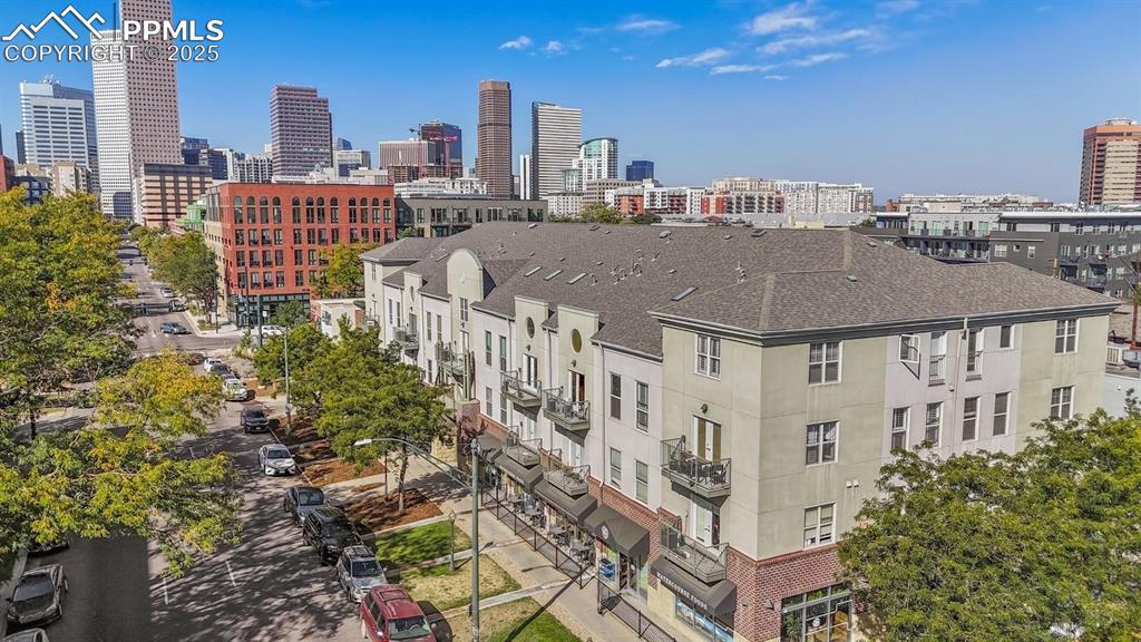 This striking residence in Denver’s Uptown neighborhood combines stylish design with outstanding proximity to dining, recreation, and cultural attractions. Vaulted ceilings and generous skylights brighten the open living area, showcasing sleek tile flooring and a dramatic accent wall that brings sophisticated energy to the space. The updated kitchen delivers both function and flair, with quartz countertops, mosaic tile backsplash, two-tone cabinetry, stainless-steel appliances, a passthrough opening—perfectly designed for everyday ease and entertaining. Upstairs, the spacious primary suite offers comfort and privacy with soft carpeting, double doors, a walk-in closet, and an en-suite bath featuring dual vanities and a tub/shower combination. A second bedroom with its own adjoining bath adds flexibility for visitors, remote work, or personal projects. Enjoy the outdoor balcony with peaceful views or take advantage of community features like the fitness center and green spaces. With two assigned parking spaces and convenient access to downtown, as well as nearby parks, cafés, boutique retailers, and landmarks like City Park and the Fillmore Auditorium, this residence puts the best of Denver within easy reach.