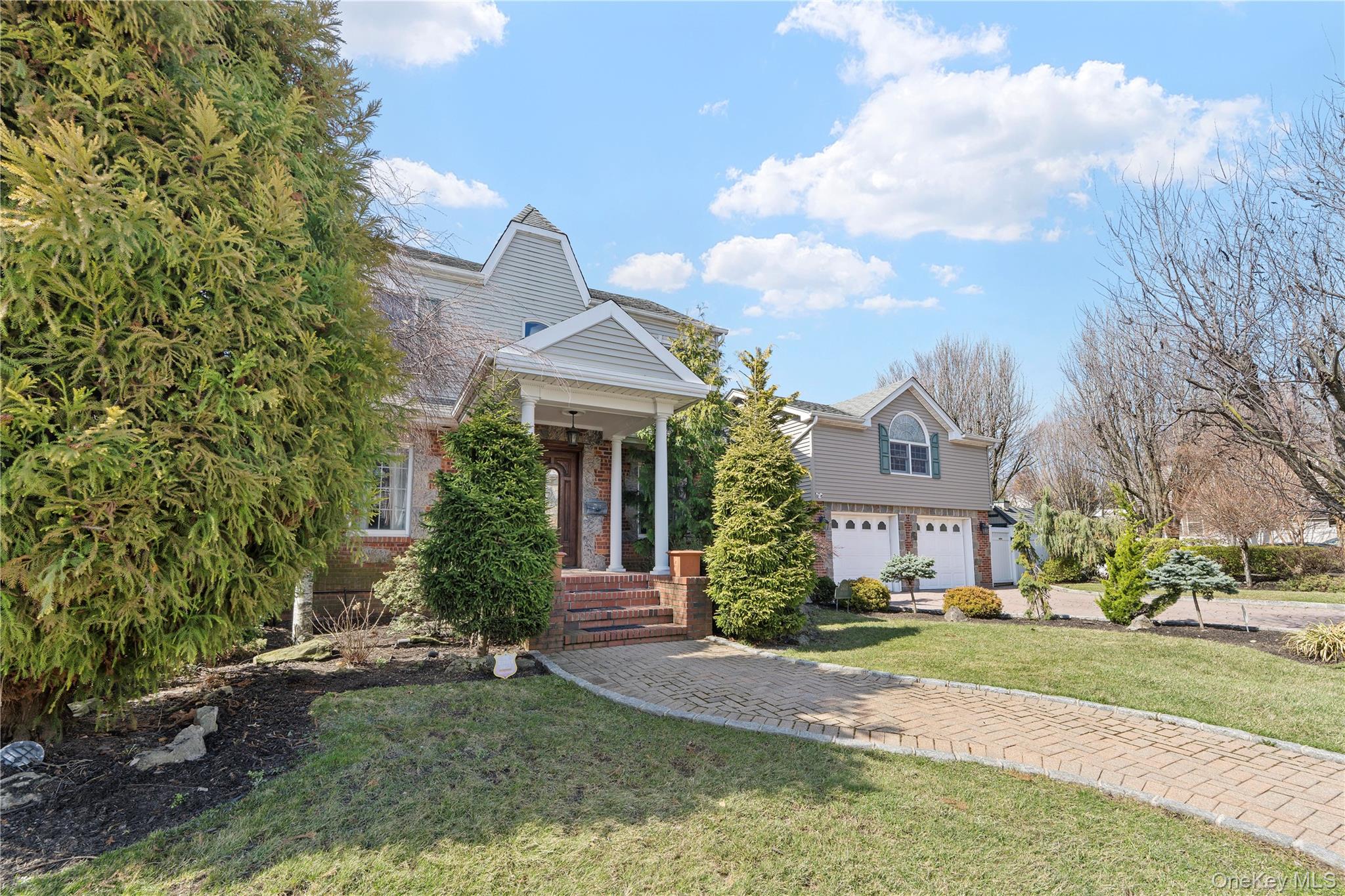 Double-size corner lot! Rare detached one-family home in the heart of Bayside, set on an oversized corner property in one of the neighborhood’s most desirable locations. This well-maintained residence offers excellent curb appeal with manicured landscaping, a paver driveway, a heated attached two-car garage, and bright, spacious interiors designed for comfortable everyday living and entertaining. Interior features include hardwood floors, a formal dining room, and generously sized rooms throughout. The layout includes a half bath on the first floor, four bedrooms and two full baths on the second floor, plus an in-law suite above the garage with one bedroom and a private full bath. The basement includes an additional full bath, and the home also offers an attic with pull-down stairs for added storage. Recent updates include a brand-new hot water heater, boiler, and heater for the saltwater pool. The backyard is a true highlight, featuring a private in-ground saltwater pool, expansive paved outdoor space, a basketball court, koi pond, an outdoor pergola complete with ceiling fan and lighting, and an outdoor kitchen area with a built-in BBQ, sink, and burner, creating a unique setting for both entertaining and everyday enjoyment. Located in sought-after School District 26 and close to parks, shopping, dining, transportation, and the LIRR, this is a rare opportunity to own a detached home on a double-size corner lot in prime Bayside.