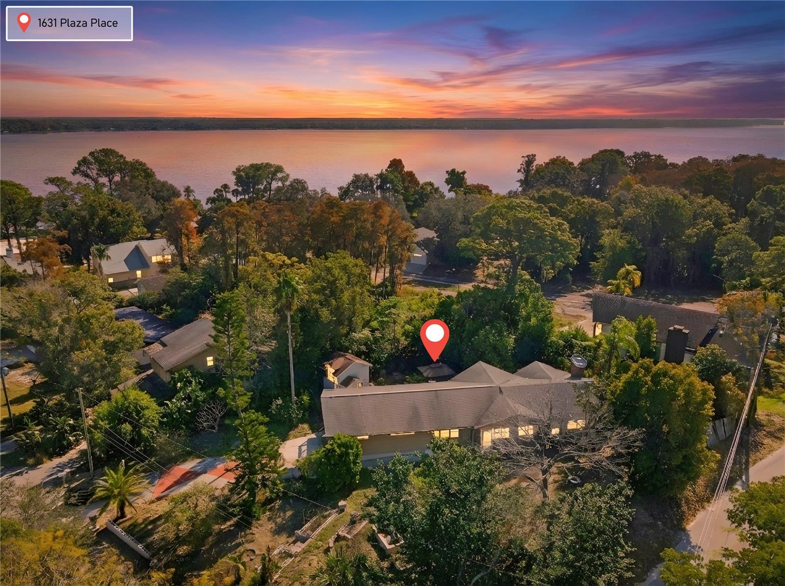 One or more photo(s) has been virtually staged. From the moment you arrive, 1631 Plaza Place feels like a hidden retreat—nestled on a high-and-dry, oversized corner lot near Lake Tarpon, where mature landscaping, natural light, and timeless character set the stage for something truly special. Step up the beautifully landscaped stairs and pathway and through the front door, where charm, space, and opportunity immediately welcome you home. Inside, you are greeted by the kitchen, thoughtfully positioned at the heart of the home. From there, the space opens into the stunning great room, featuring soaring wood ceilings, a wood-burning fireplace, and expansive windows that frame serene views of the surrounding property, with a subtle glimmer of Lake Tarpon visible through the trees. Abundant natural light fills the space, creating a warm and inviting atmosphere ideal for both everyday living and entertaining.The primary suite offers a peaceful retreat, complete with its own wood-burning fireplace and an ensuite bathroom featuring a soaking tub, dual vanities, and plentiful natural light streaming through surrounding windows. On the opposite side of the great room, two additional bedrooms and bathrooms provide comfort, privacy, and flexibility for family or guests. This wing of the home also offers access to a deck and balcony overlooking the enchanting backyard—an outdoor setting that feels both private and serene.The backyard is truly something special, featuring two fountains, thoughtfully designed gardens, chicken coops, and a paved area ideal for entertaining or relaxing outdoors. Mature fruit trees, including starfruit and orange trees, beautifully showcase the Florida lifestyle and add to the property’s unique character and charm.Downstairs, a separate bedroom, bathroom, and bonus room offer exceptional versatility—perfect for entertaining, a game room, guest suite, or private retreat—with direct access to the large garage. This flexible layout enhances both livability and long-term potential.Located near top-rated schools, historic and downtown Tarpon Springs, Sunset Beach, and Fred Howard Park, this property combines location, character, and opportunity in one rare offering. Ideal for investors or buyers seeking to customize a luxury residence, this home invites you to bring your vision to life and discover what makes this opportunity so special. Offered as-is, this property presents an excellent value-add opportunity with significant upside potential! Schedule your private showing today.