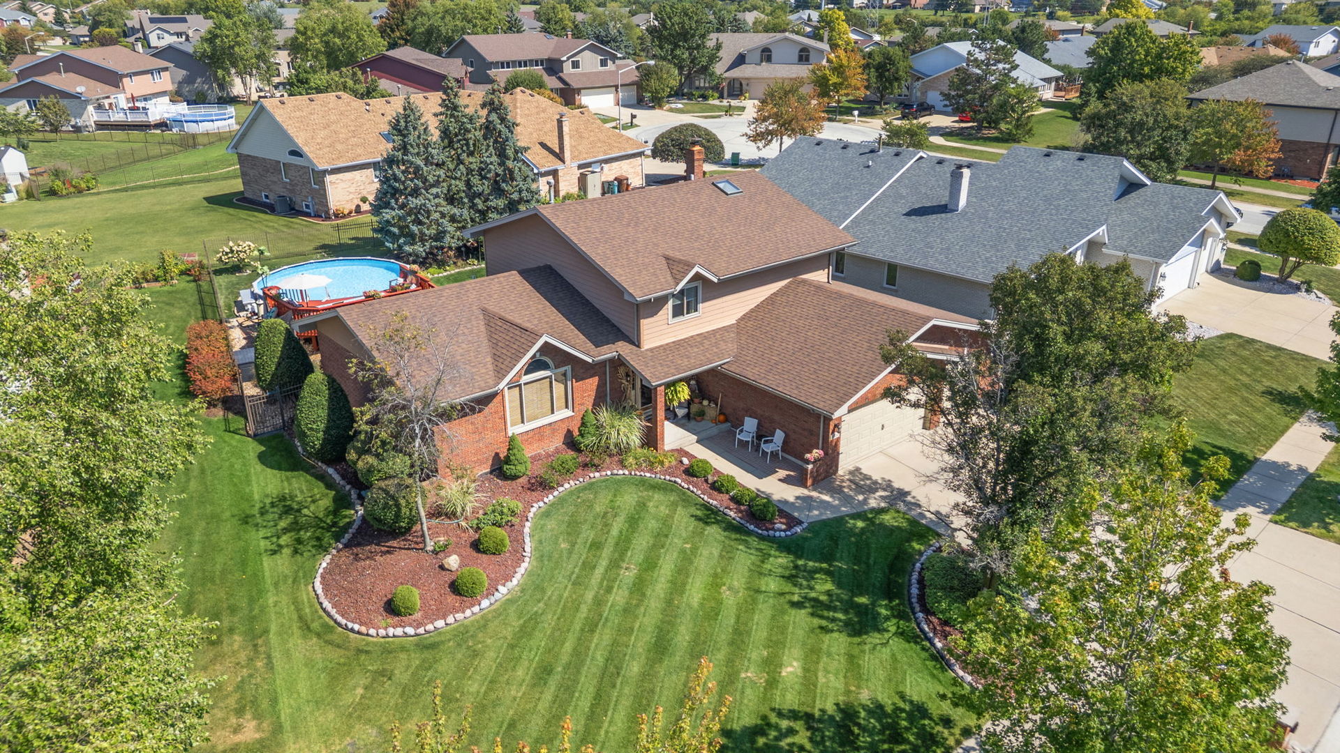 First time ever on the market! Don't miss this stunning, one of a kind home in the highly sought after Brookside Glen of Tinley Park. Impeccably maintained by it's original owner and move-in ready, this home is packed with perks inside and out and is perfect for entertaining all year round. From the moment you pull up, pride of ownership is evident with gorgeous curb appeal and meticulous landscaping. Step inside the spacious foyer and be greeted by soaring cathedral ceilings with exposed beams. The main level offers a ton of living space between the front living room, dining room, kitchen & family room. The eat-in kitchen is a chef's dream with ample cabinet & counter space, a pantry closet, stainless steel appliances (new double oven!), a breakfast bar, plus room for a table. It opens seamlessly into the cozy family room with a brick, wood-burning fireplace. Perfectly tucked away off the family room is the 4th bedroom-ideal for guests, an office, or a playroom. The laundry/mud room is conveniently located on the main level as well. Upstairs offers 3 generously sized bedrooms + a full hallway bathroom. The primary suite boasts cathedral ceilings, a walk-in closet, and a full, attached bathroom with a separate tub and shower along with a double vanity sink. The custom & cozy, Northwoods-inspired basement is a true showstopper, perfect for hosting winter parties or simply relaxing at home. With 10-ft ceilings, a stone fireplace, bar with seating, reading nook, and half bath, no detail was overlooked! Plenty of storage options as this home is partial basement/partial crawl. Step outside to your backyard oasis-an entertainer's dream! Enjoy the oversized concrete patio, brick paver patio, and custom stone bar with gas grill and added storage. The 24-ft round, heated pool (only 8 years young) and connecting deck are ready for summer fun. Fully fenced yard for privacy and peace of mind. The 3-car attached garage is insulated and drywalled. Close to I-80, Metra, parks, trails, shopping, and dining. Located in Frankfort's 161 School District and award-winning Lincoln Way East High School. Between the home itself and the incredible location, this home truly has it all!