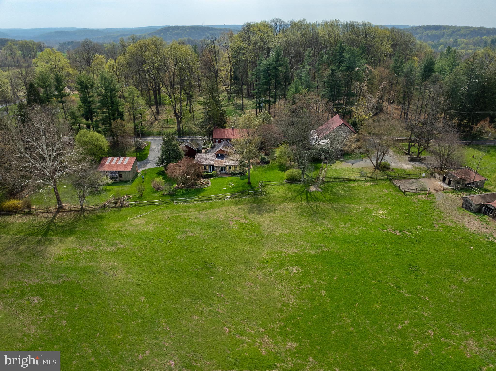 Colonial charm meets timeless character in Chester Springs at Saint Matthews Place farm! Located at 1169 Saint Matthews Road in West Vincent Township, this one-of-a-kind historic home dates back to the 18th century and beautifully blends its original architecture with thoughtful additions completed in 1980 and the 2010. Set on 7.4 acres,  the 3,614 square foot  home features a front sitting patio and a large enclosed brick patio overlooking the backyard and pastures—perfect for entertaining and tranquility. The home offers 3 bedrooms, 3 full baths, and 2 half baths, with both levels showcasing distinctive architectural character enhanced by hardwood and tile flooring throughout. A bright sunroom with floor-to-ceiling windows/sliding doors and a classic brick floor overlooks picturesque scenery. A spiral staircase leads to a loft featuring a striking floor-to-ceiling built-in bookcase. All three bedrooms include ensuite bathrooms—the loft offers a half bath, while the remaining two feature full baths. A third full bath is on the main level off the living room, complete with a standing shower and separate bathtub with a tub rail. The home also includes convenient laundry on both the main level and in the basement.Equestrian enthusiasts will appreciate the impressive outdoor amenities, including a large bank barn, built with local stone that features 10 stalls, a tack room, a blanket room, a tool room, a half bath, and extensive upper-level storage for feed, farm equipment or carriages. The barn opens directly into one of two pastures, which together feature four run-in sheds and a feeding trough. The approximate acreage of the two pastures together equals approximately 4.6 acres of open land. The property also includes a newer oversized three-car garage, along with two separate driveways—one serving the home and one the barn. This exceptional property offers timeless character, functional space, and a rare opportunity to own a piece of history.