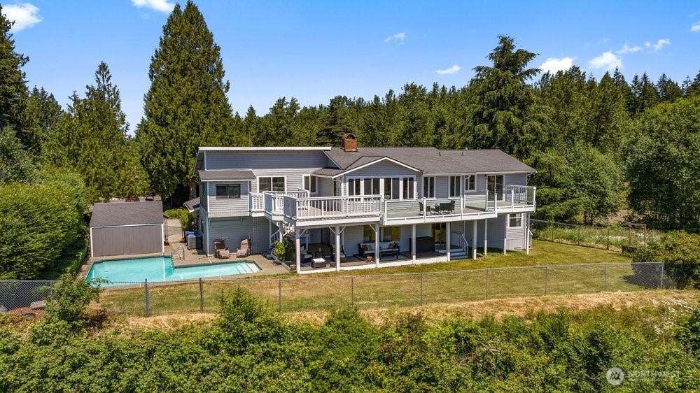 Crowning the most coveted position in a private cul-de-sac, this retreat claims the single best vantage point on the street—and quite possibly the valley. From its commanding elevation, your home looks out over nearly an acre of your own land toward Mt Rainier, standing in all her glory. Trade highway noise for the serene sounds of wild birds. Imagine sipping your morning coffee from the sun-drenched deck, the mountain glowing at sunrise & the valley unfolding beneath you. There's room for everyone to spread out—& a view from nearly every angle. Step inside to a beautifully reimagined kitchen, fresh paint inside & out, & a clean, light-filled feeling throughout. Relax in one of your many indoor & outdoor view areas, then drift out to the massive Trex deck—front-row seats to PNW grandeur, built for entertaining or simply soaking it all in. Enjoy year-round swimming in your heated in-ground pool. W/ only a handful of neighboring homes on this shy-acre parcel, privacy & seclusion come standard. The location delivers the best of both worlds—tucked-away tranquility with everything close at hand. You're minutes from Highways 18 & 164 for an easy commute in any direction, just down the road from the Green River & Lake Holm, & a short drive to Muckleshoot Casino, shopping, dining, & the Washington National Golf Club. A rare blend of elevation, privacy, & effortless indoor-outdoor living—and an incredible value at this price! This is the view everyone wants. Now it can be yours.