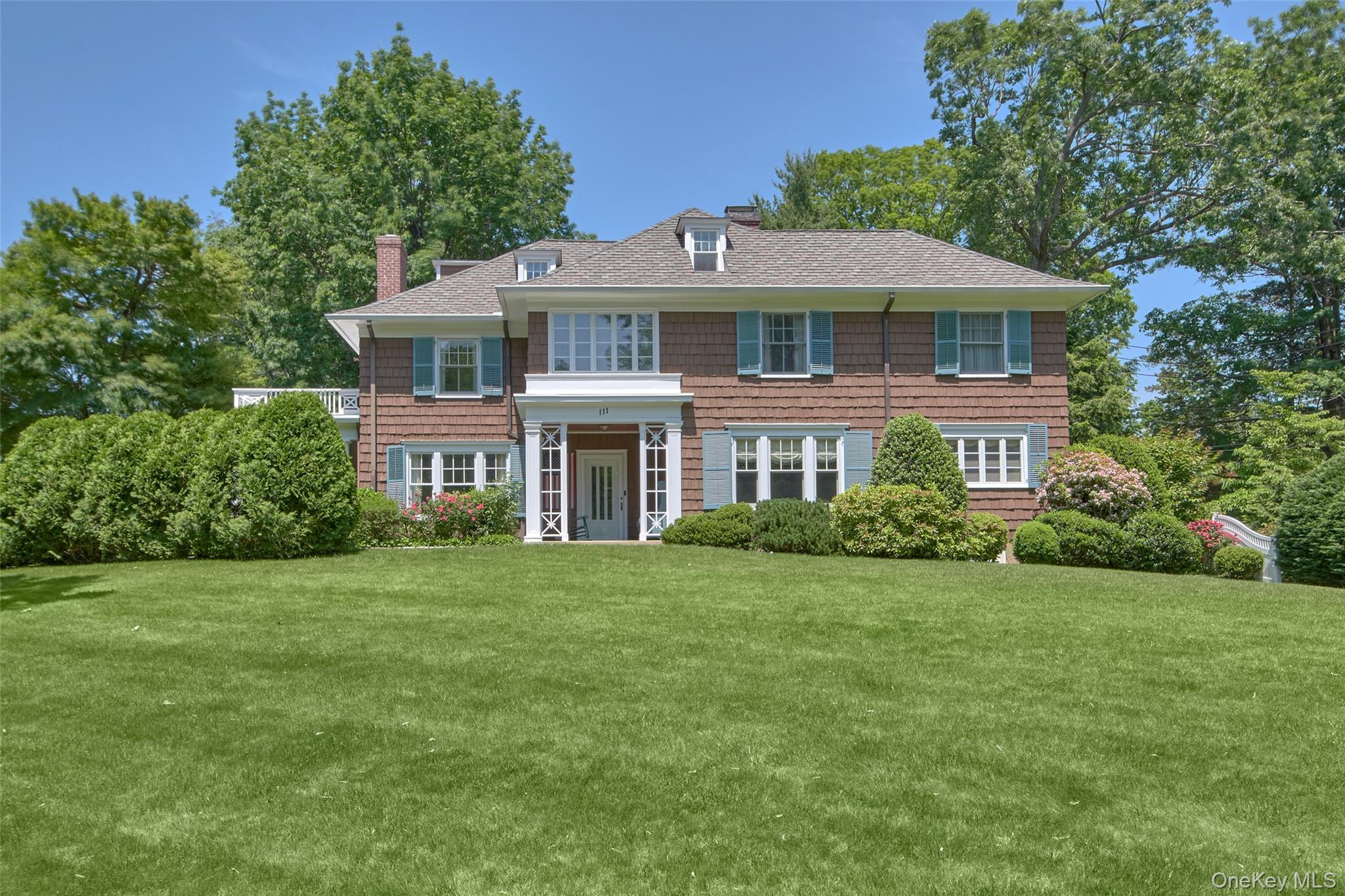 Exquisite architectural design, timeless charm & luxurious modern amenities merge effortlessly in this elegant Colonial in the heart of Chappaqua. C.1902 & superbly upgraded and meticulously maintained, the home offers an open, sun-bathed interior w/hardwood floors, high ceilings, abundant built-ins, extensive millwork and a quintessential porch - sure to please the most discerning buyers! The gracious foyer leads to a classic dining room with fine millwork, a fireplace and boasts a lovely historical handpainted mural of the Hudson Valley at the turn of the century. The formal living room with concealed pocket doors has a second fireplace and French doors opening to the covered porch. The sunny and bright eat-in kitchen is a chef’s dream featuring a Wolf double oven, Sub Zero fridge, ample storage and opens to the casual living room/ leisure room.  2nd floor features a primary bedroom suite with a sparkling spa bath, walk-in closet and and adjoining office. An additional 3 bedrooms and a tastefully renovated hall bath complete the second floor. Finished 3rd level includes a bedroom and Bonus room perfect for studio/office/playroom  w/ full hall bath. The large unfinished basement offers additional space and Bilco doors to the exterior. A 2 car detached garage originally used as stables has 2 levels and offers many possibilities. The park-like, level  property is professionally landscaped and is an oasis of tranquility w/ lush lawns, a dazzling variety of specimen trees & plantings with ample parking. Ideally located close to town, train, schools and more!