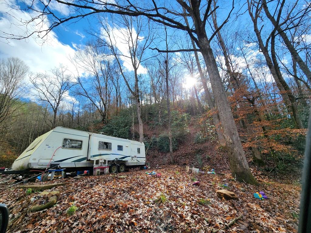 Unrestricted residential lot with well, septic and electric.  Opportunity for the right buyer, willing to clean up and haul away unwanted items and place another home or RV on the property.  DW is uninhabitable. Property is being sold "AS IS". Buyer is responsible for removal of mobile,camper and any other items on property.